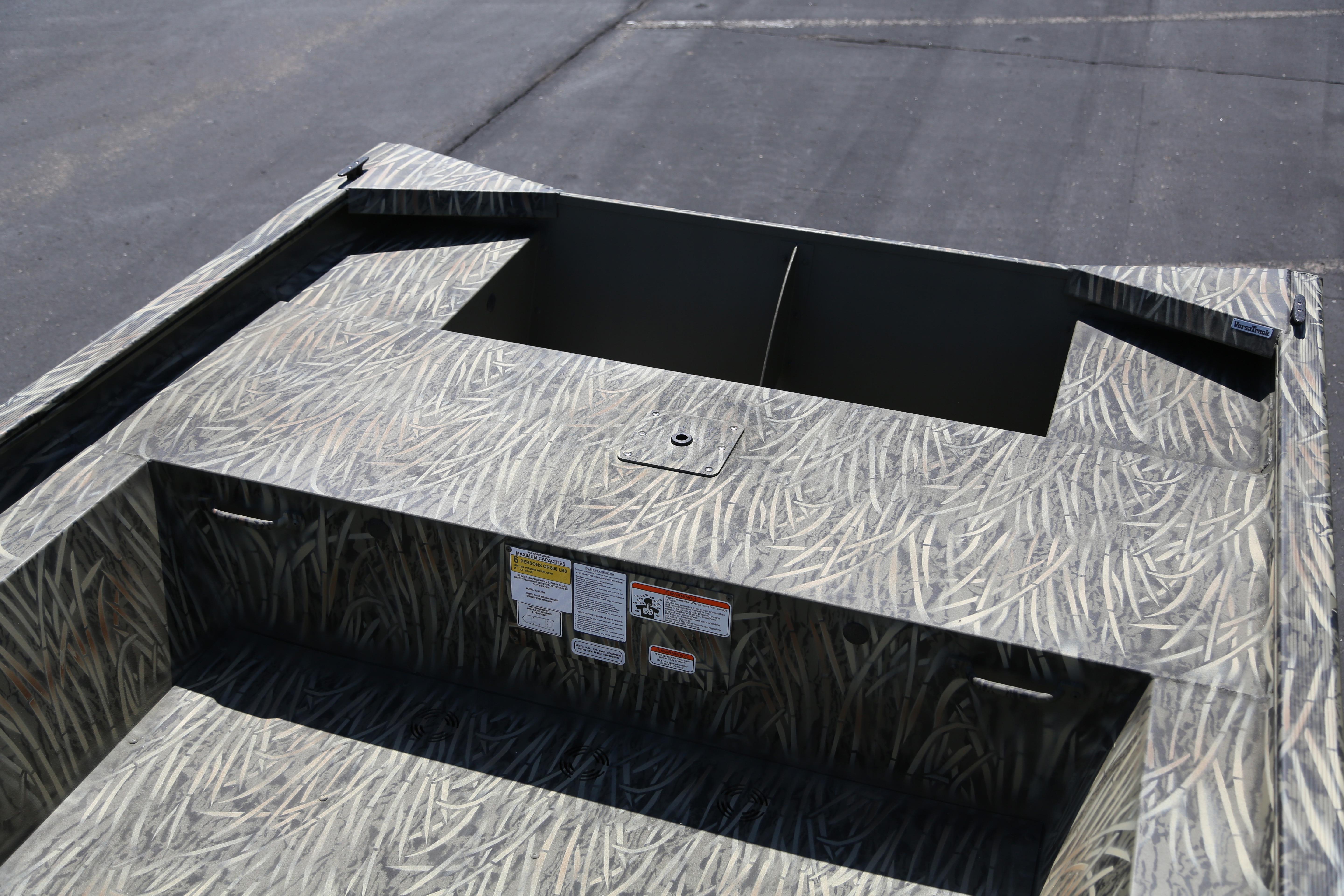 2026 Tracker Grizzly 1754 Utility boat with camouflage design on a paved surface.