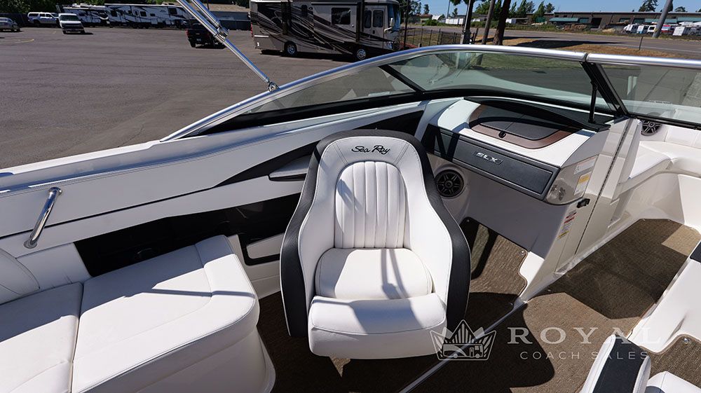 Interior view of a Sea Ray SLX 230 boat with white seating and helm console.