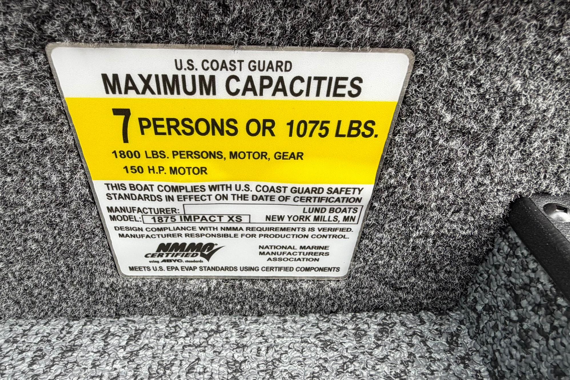 2027 Lund 1875 Impact XS Sport capacity label: 7 persons or 1075 lbs, 150 HP motor.