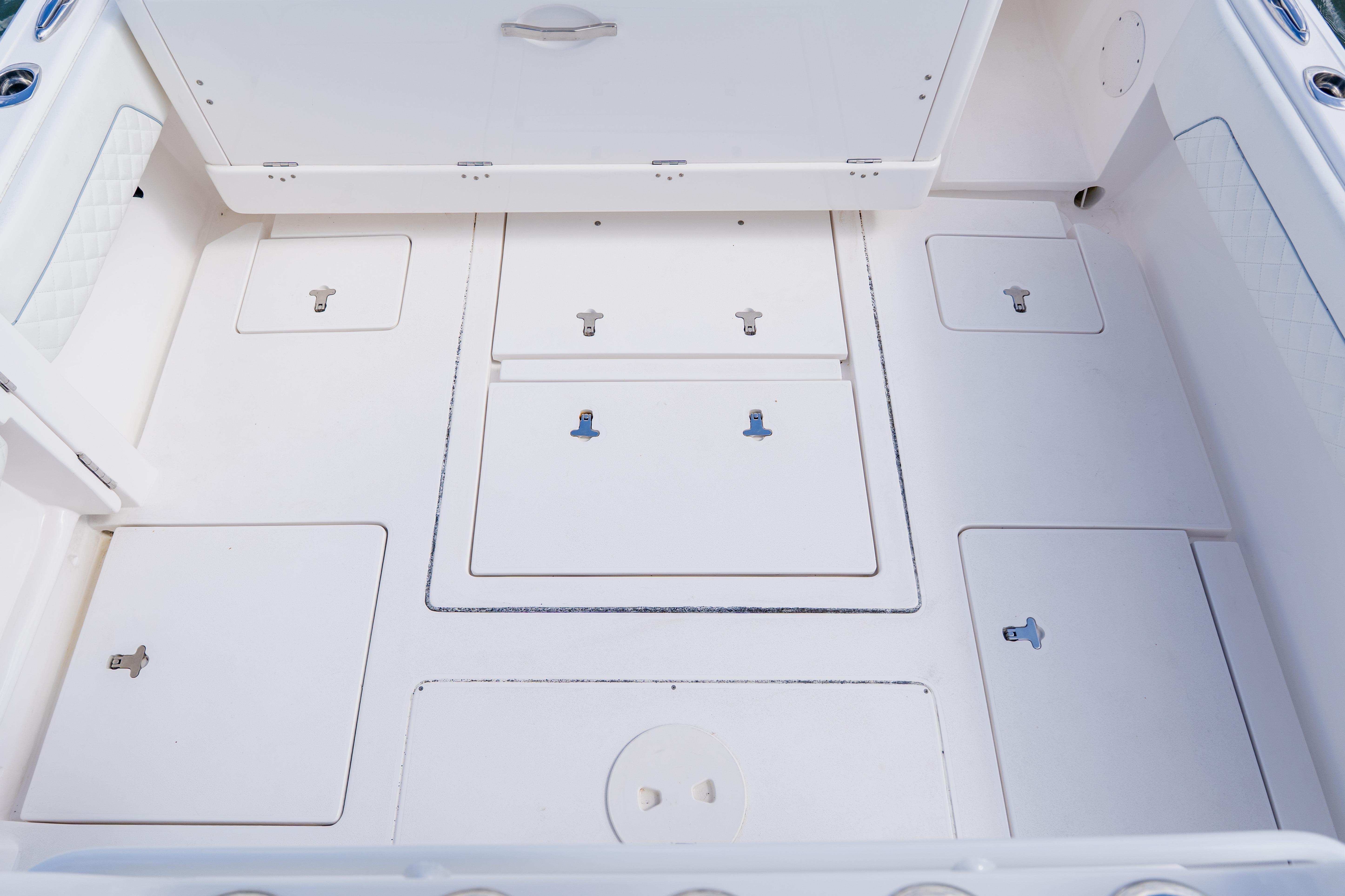 2018 Intrepid 327 Center Console boat deck with multiple storage compartments.