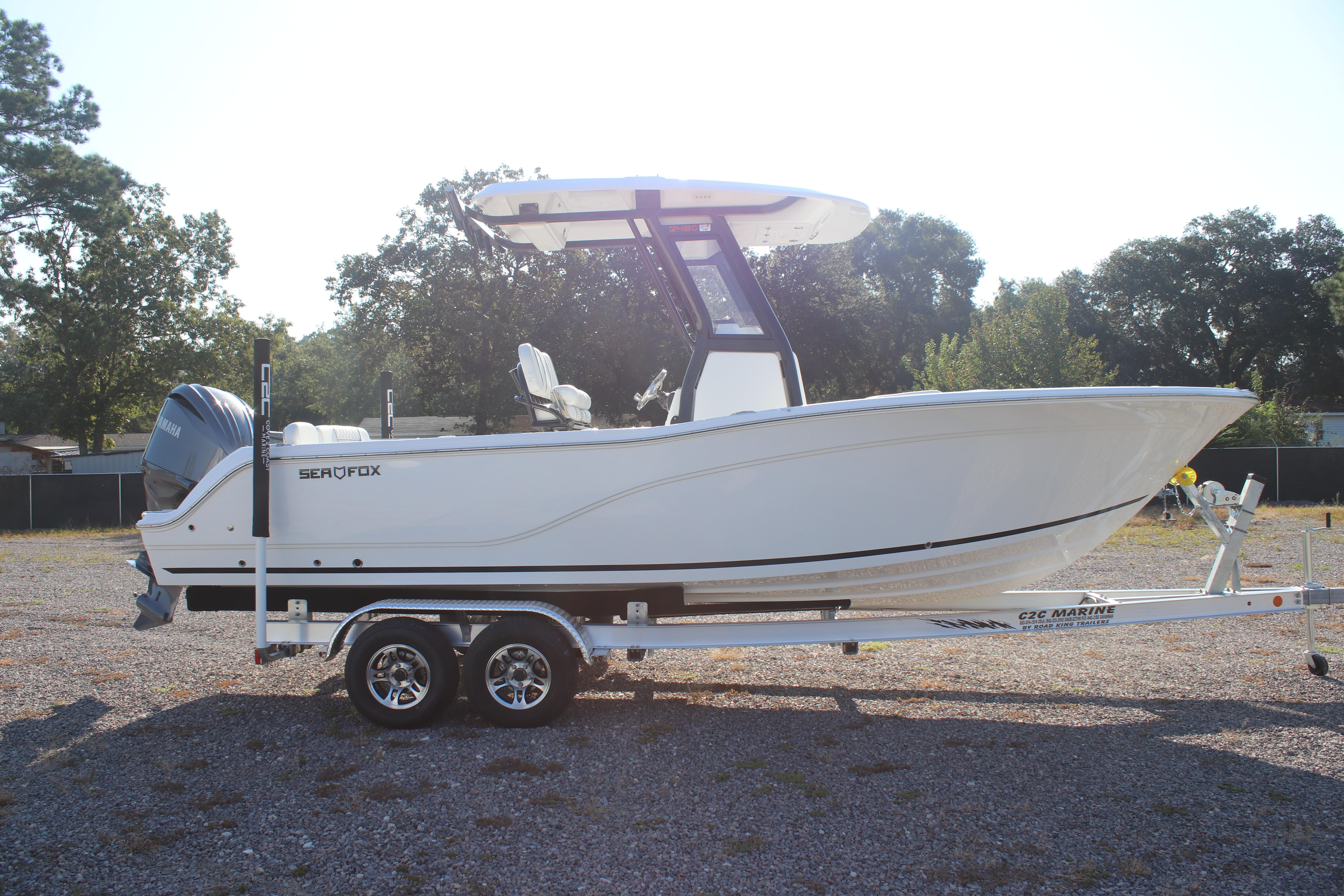 2026 Sea Fox 248 Commander boat on trailer, parked outdoors.