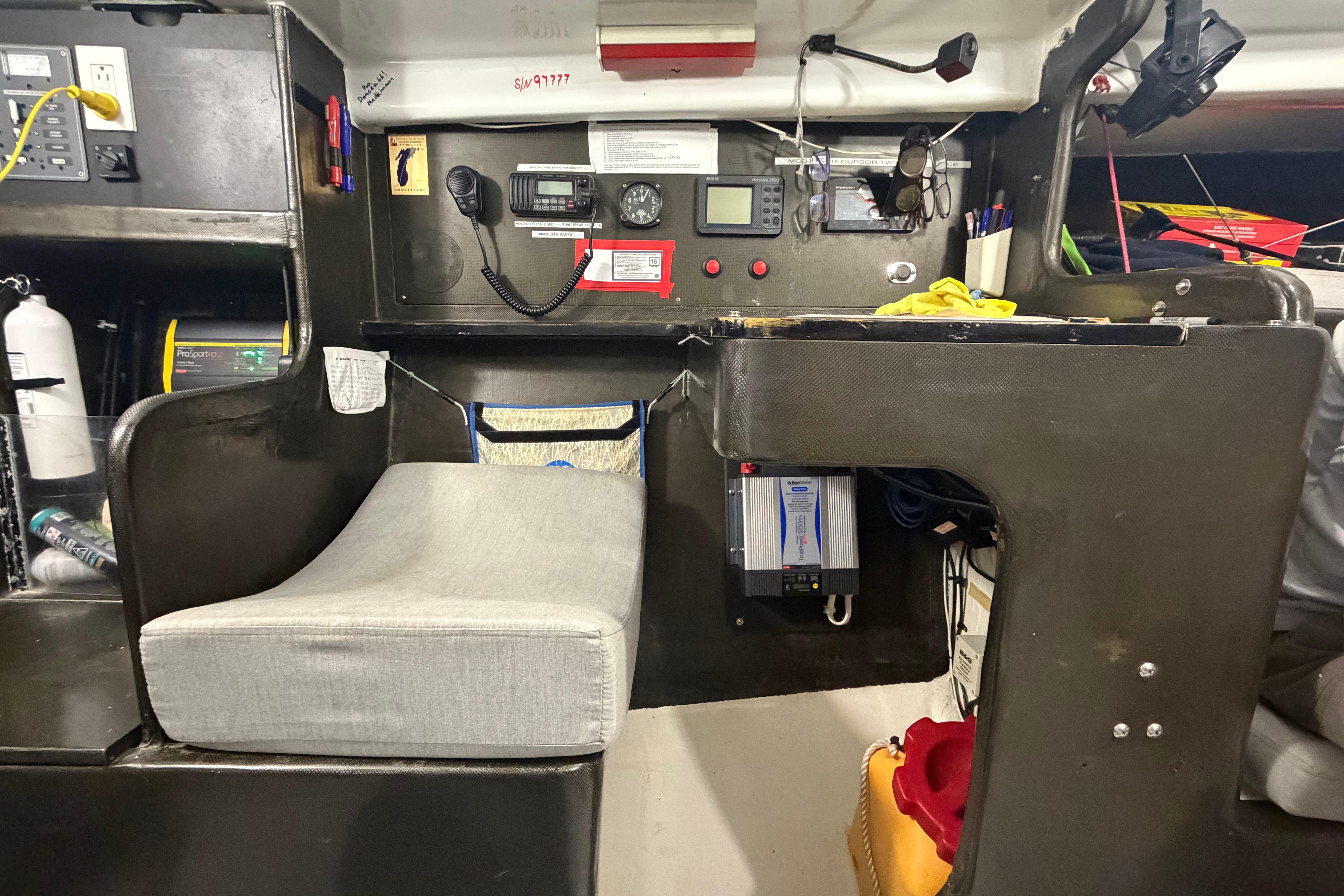 Interior of an Andrews 63 sailboat featuring navigation equipment and seating area.