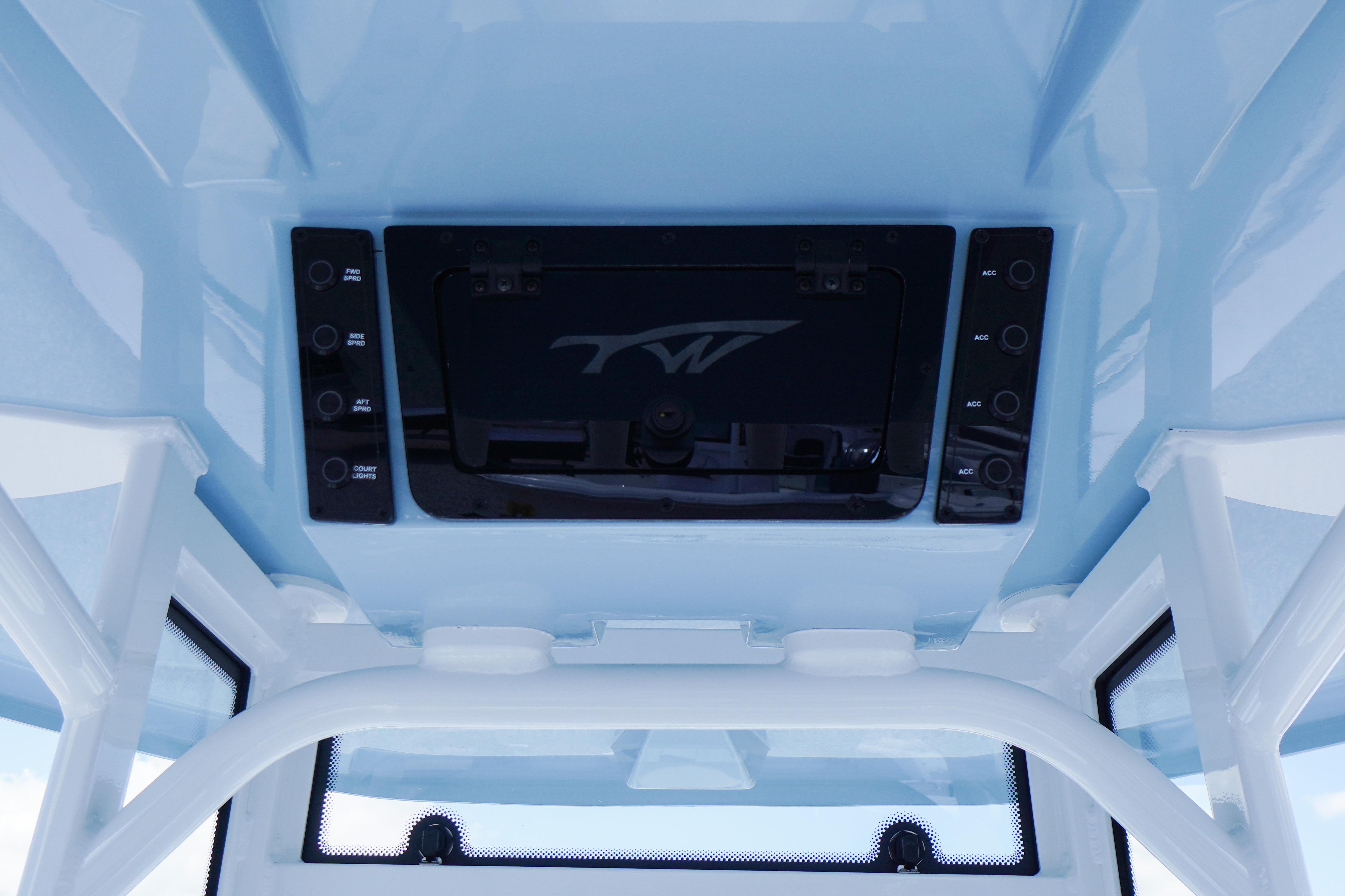 2027 Tidewater 220 LXF boat console with control panel and overhead storage.