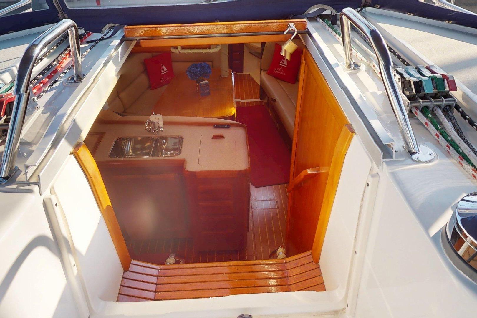Interior view of 1997 Hunter Legend 40.5 sailboat, featuring cozy cabin and kitchenette.