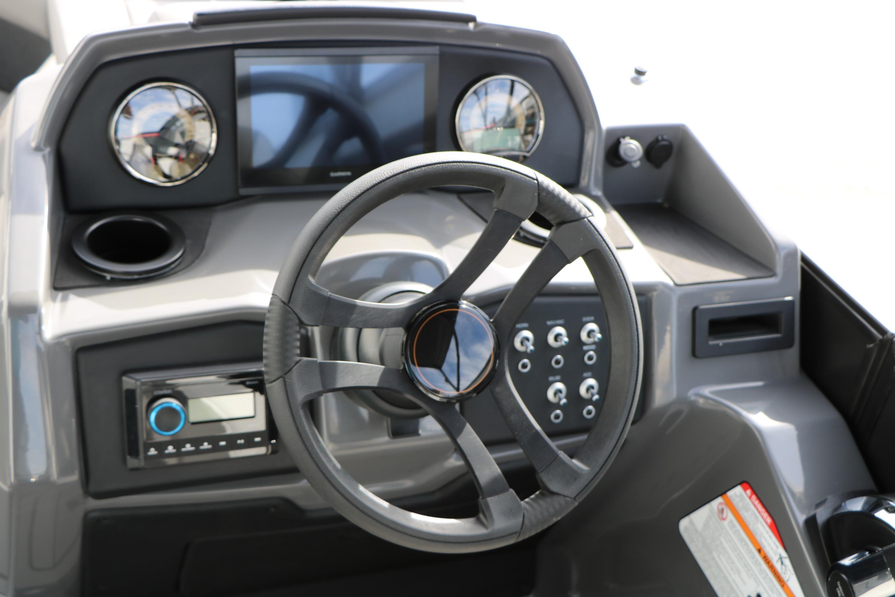 Steering console of 2026 Evotti 521QL boat with modern controls and display.