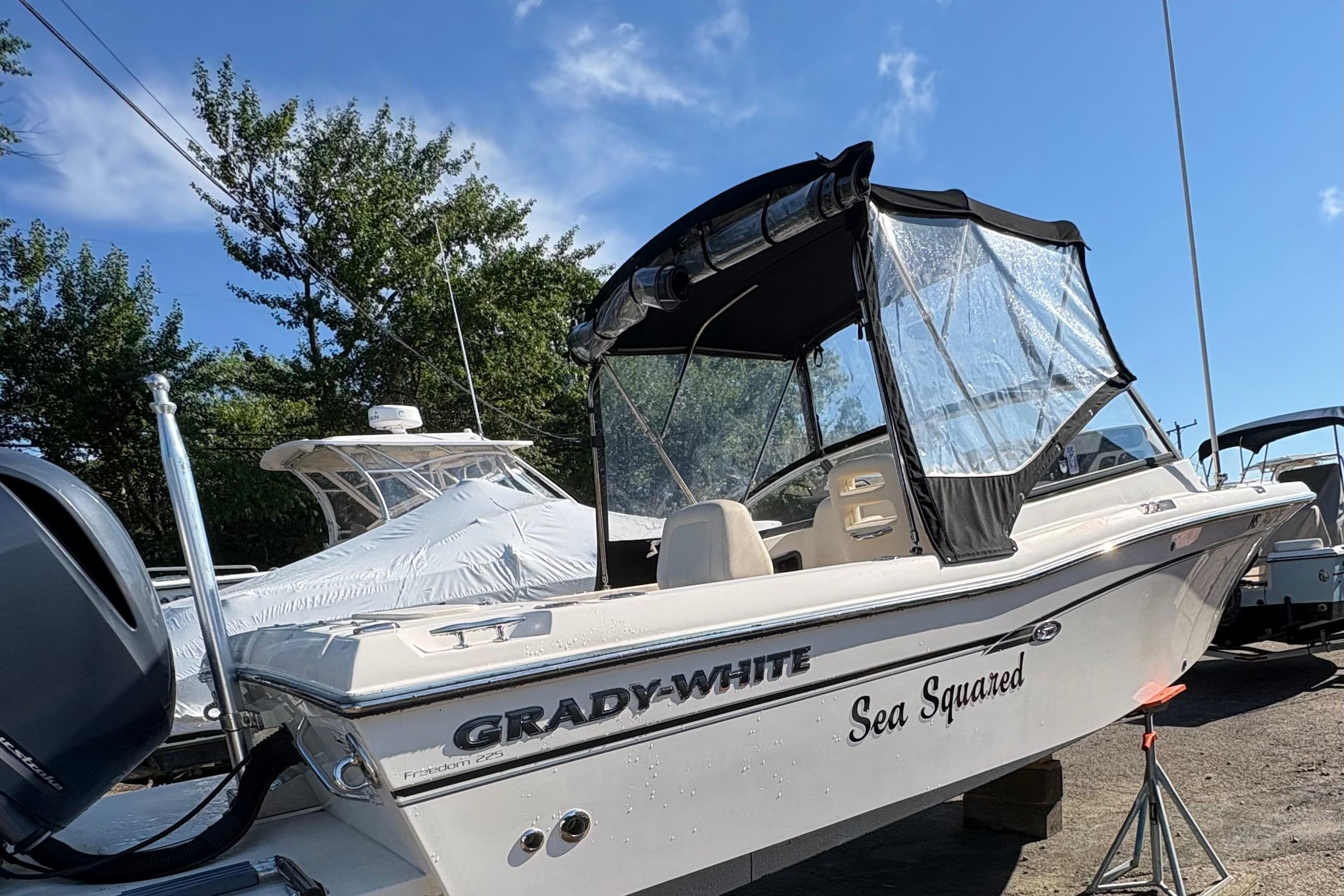 2015 Grady-White Freedom 225 boat with canopy, named "Sea Squared," on display outdoors.
