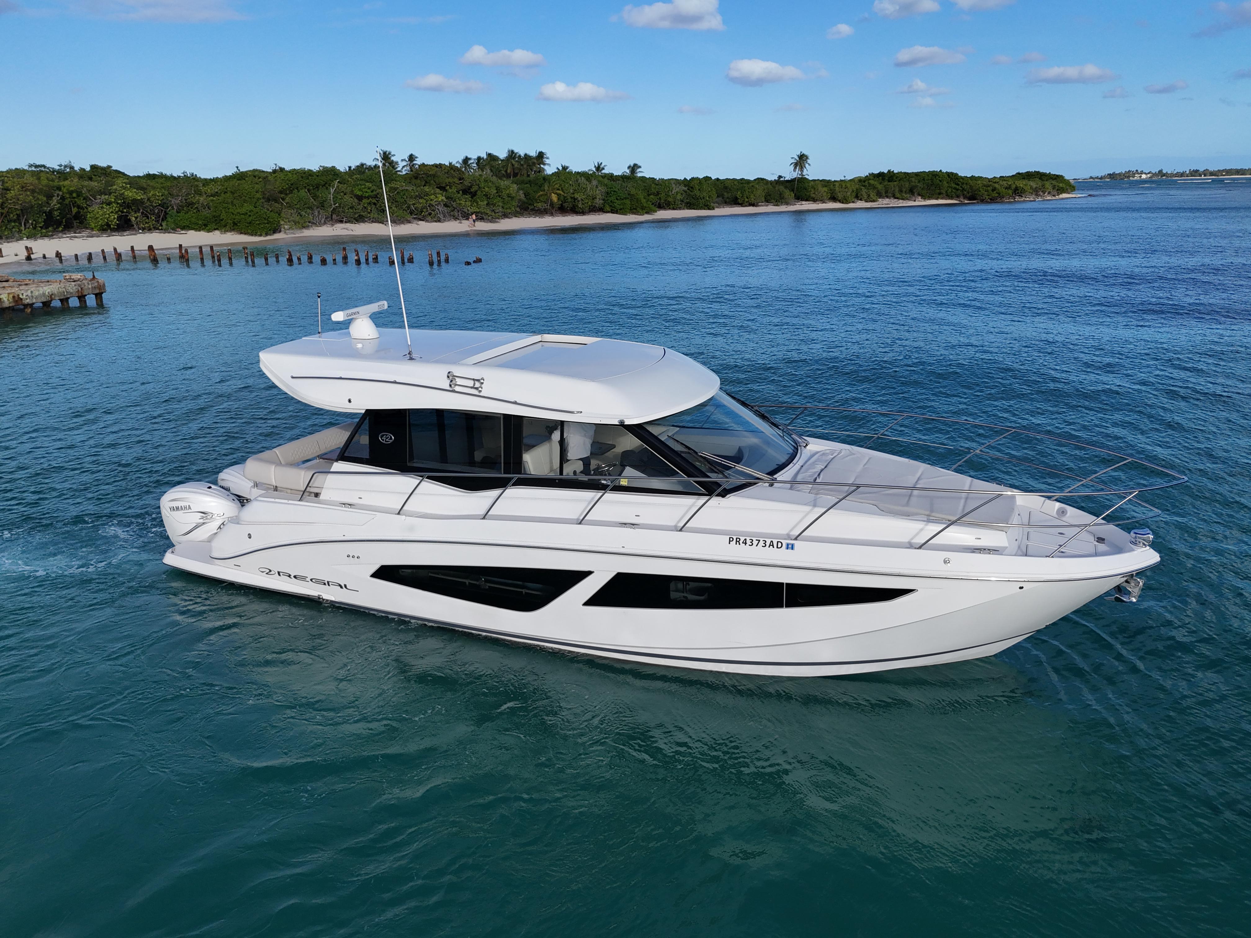 2022 Regal 42 XO yacht cruising on clear blue water.