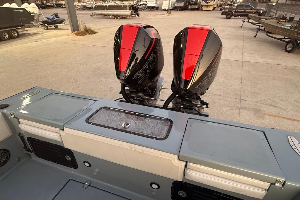 2019 Metal Shark 28 CC boat with dual outboard motors in a marina setting.