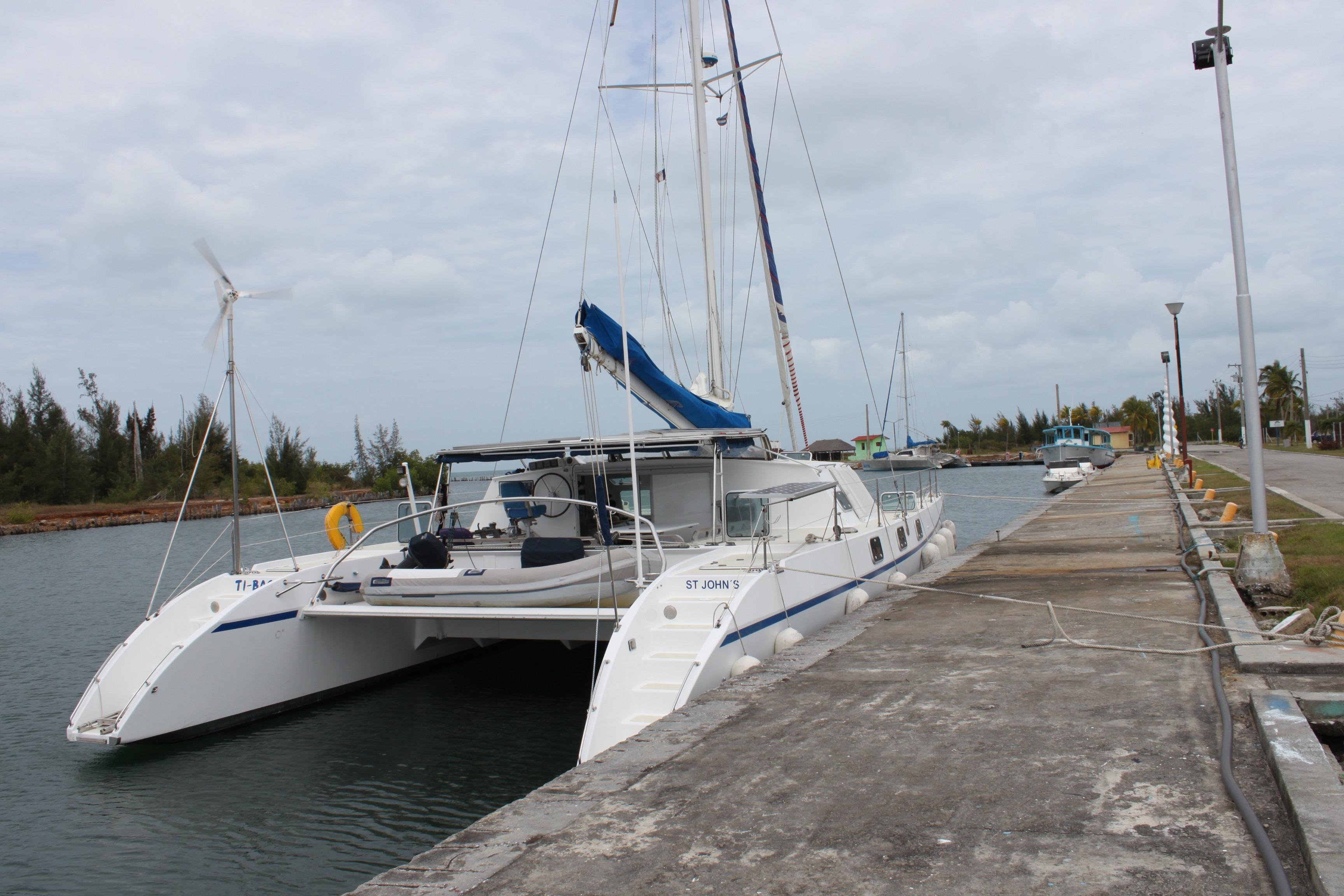 Catamaran "Tropic 56" docked at marina, overcast sky, 1997 Naval Force 3 model.