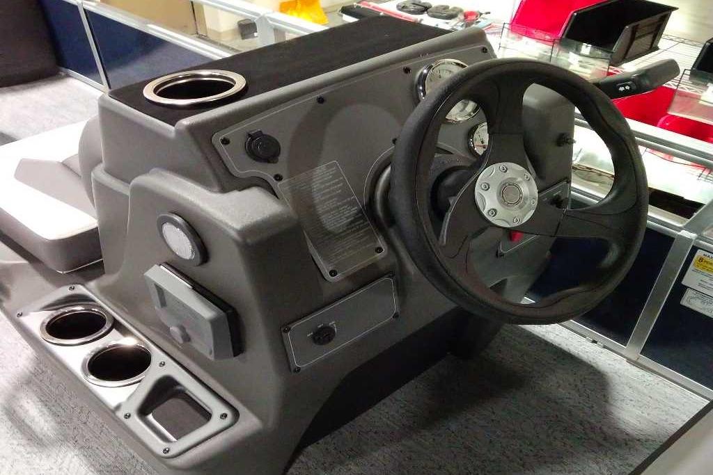 2026 Sun Tracker Bass Buggy 18 DLX steering console with cup holders and controls.
