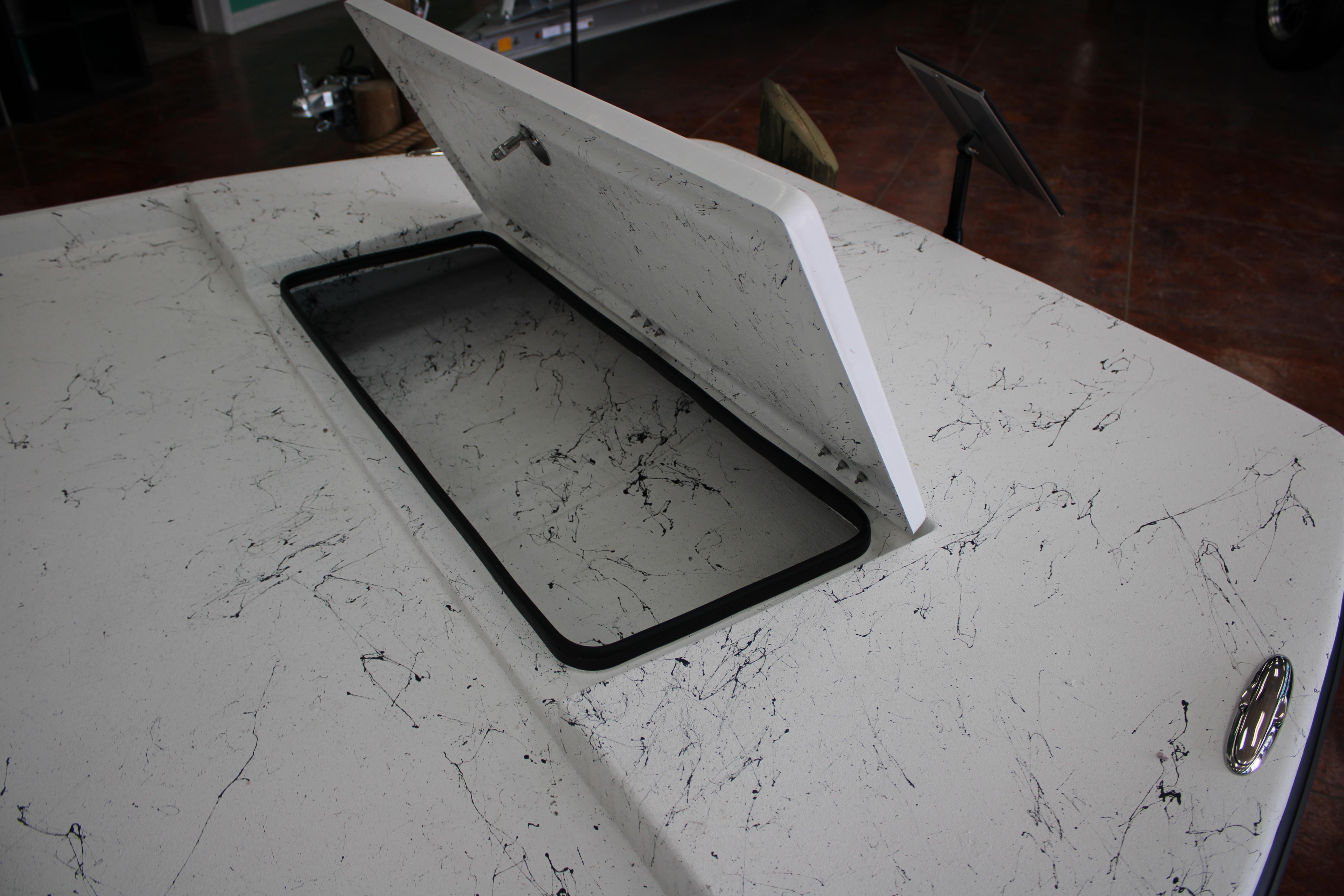2026 Freedom Boats Chiquita with open hatch, showcasing marbled deck design.