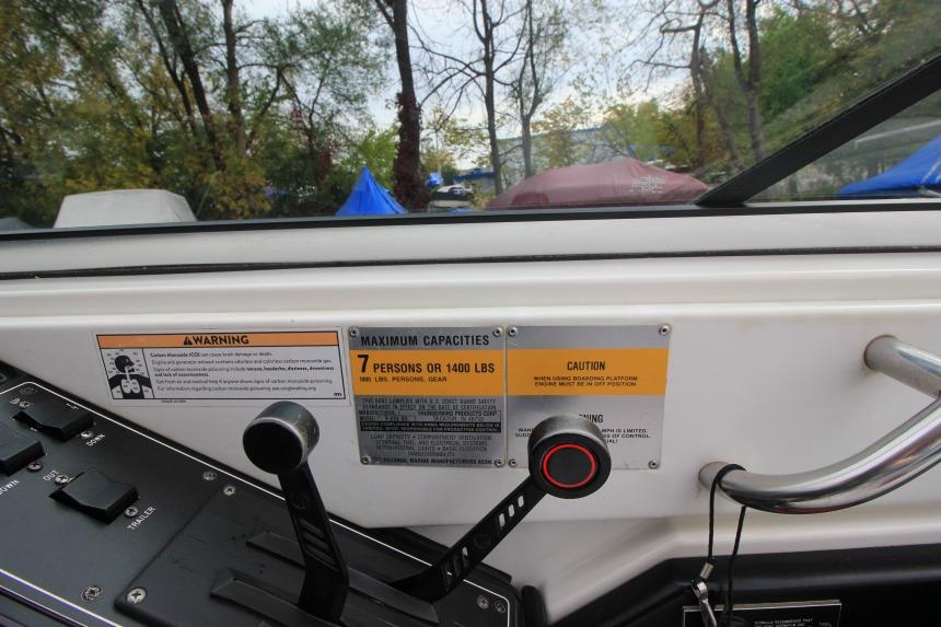 Control panel of a 1989 Formula 223 SS boat with capacity warning labels.