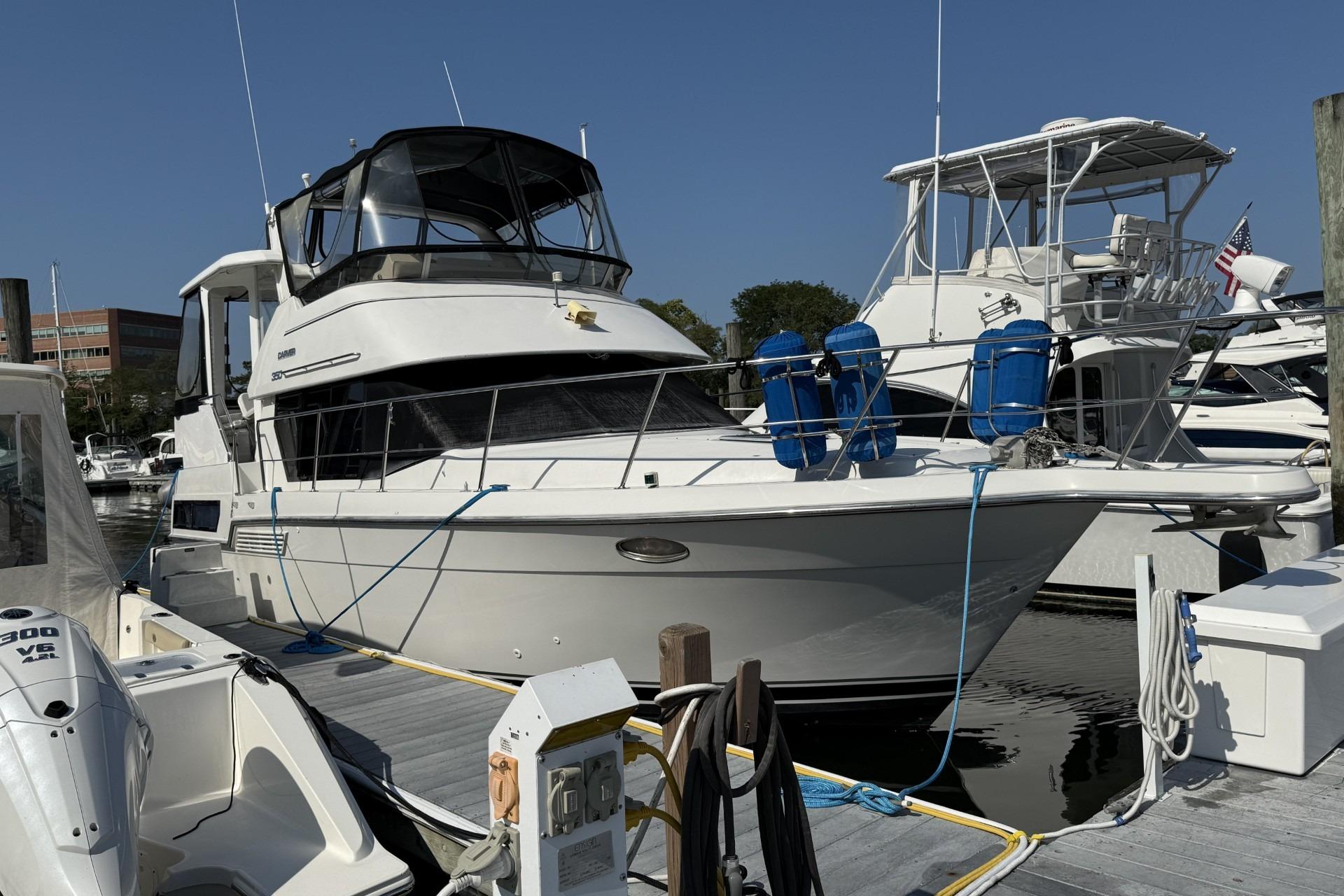 1993 Carver 350 Motor Yacht docked at marina, clear sky, other boats nearby.