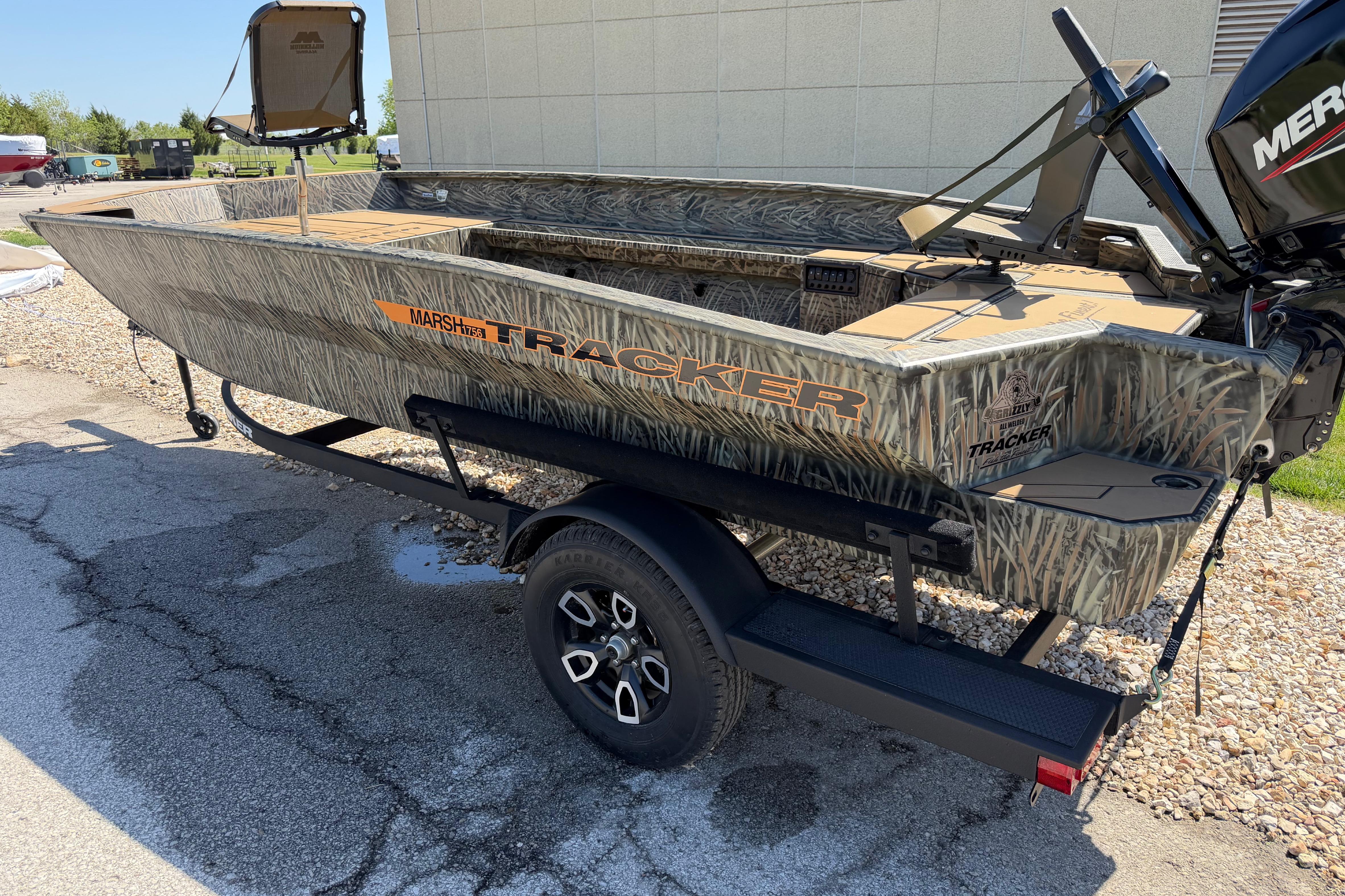 2026 Tracker Grizzly 1756 T Marsh boat with camouflage design on a trailer.