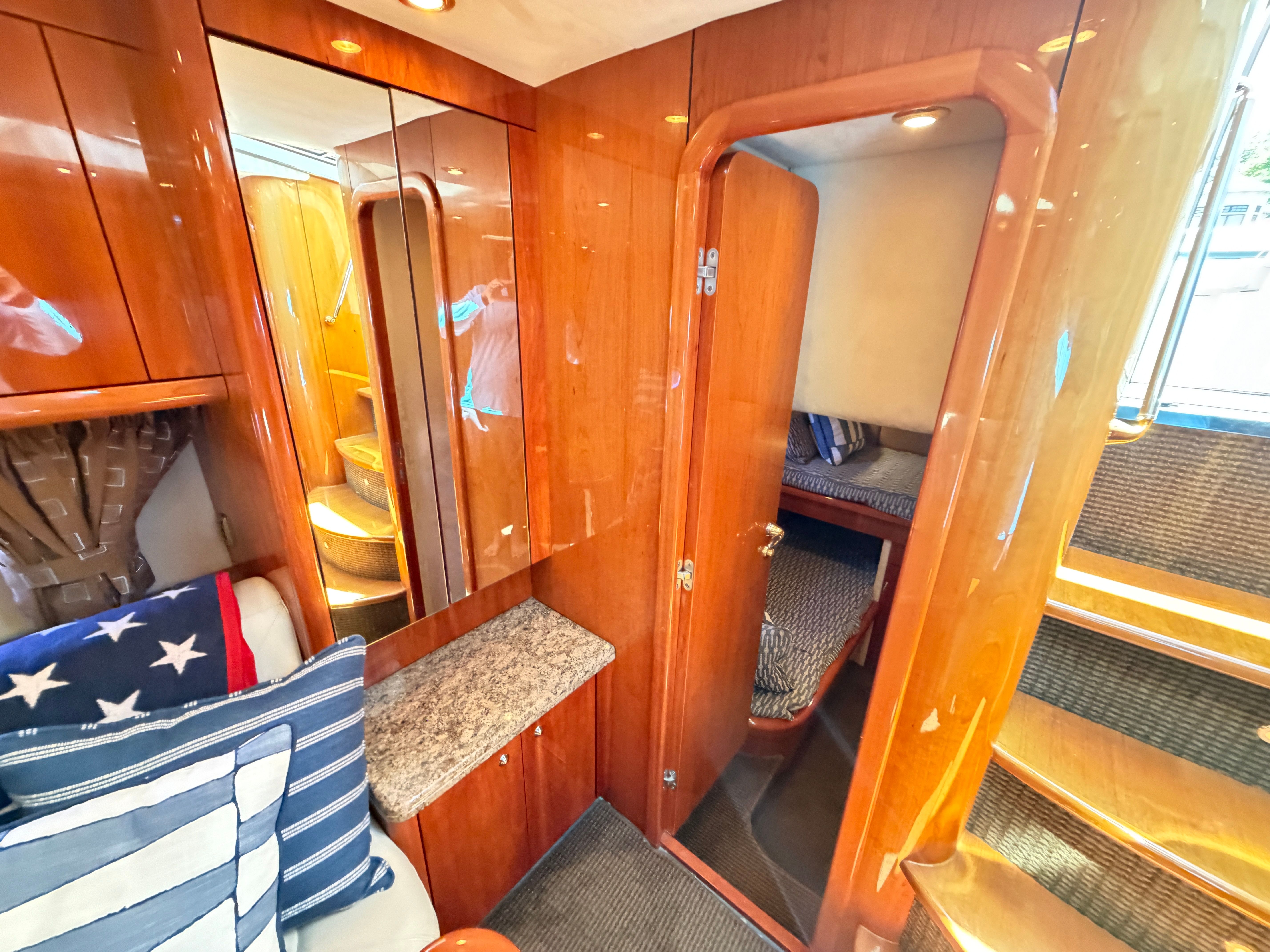 Interior of a 2008 Sunseeker Portofino 53 with wood finish and stairs.