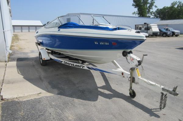 1993 Rinker 186 Captiva boat on ShoreLand'r trailer in parking lot.