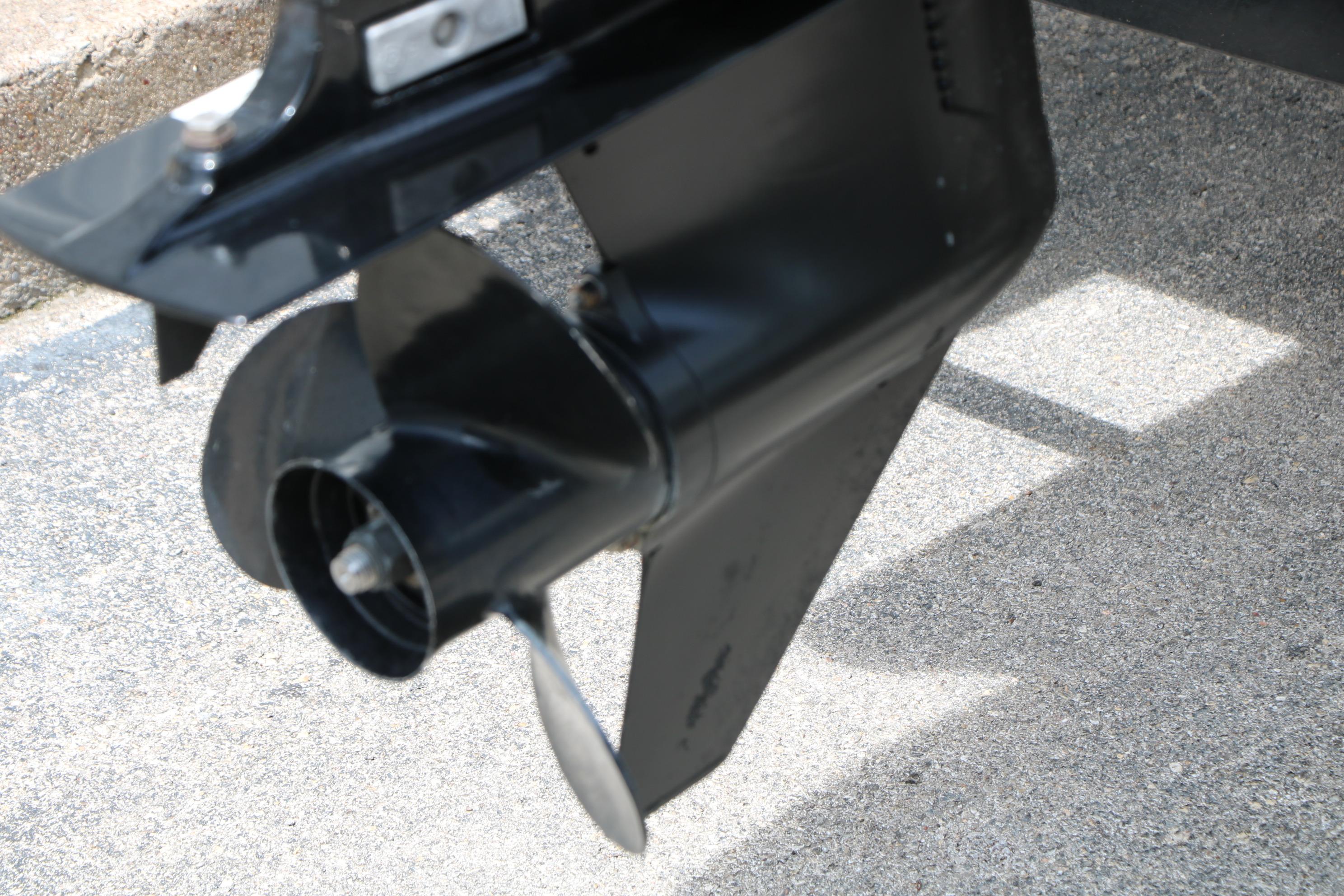 Propeller of a 2013 Sun Tracker Fishin' Barge 20 DLX on concrete surface.