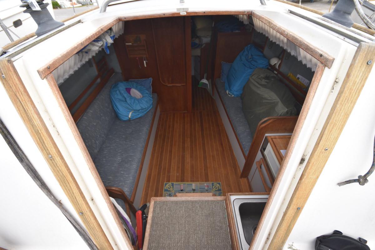 Interior of a 1987 S2 9.2A sailboat with wooden flooring and seating areas.