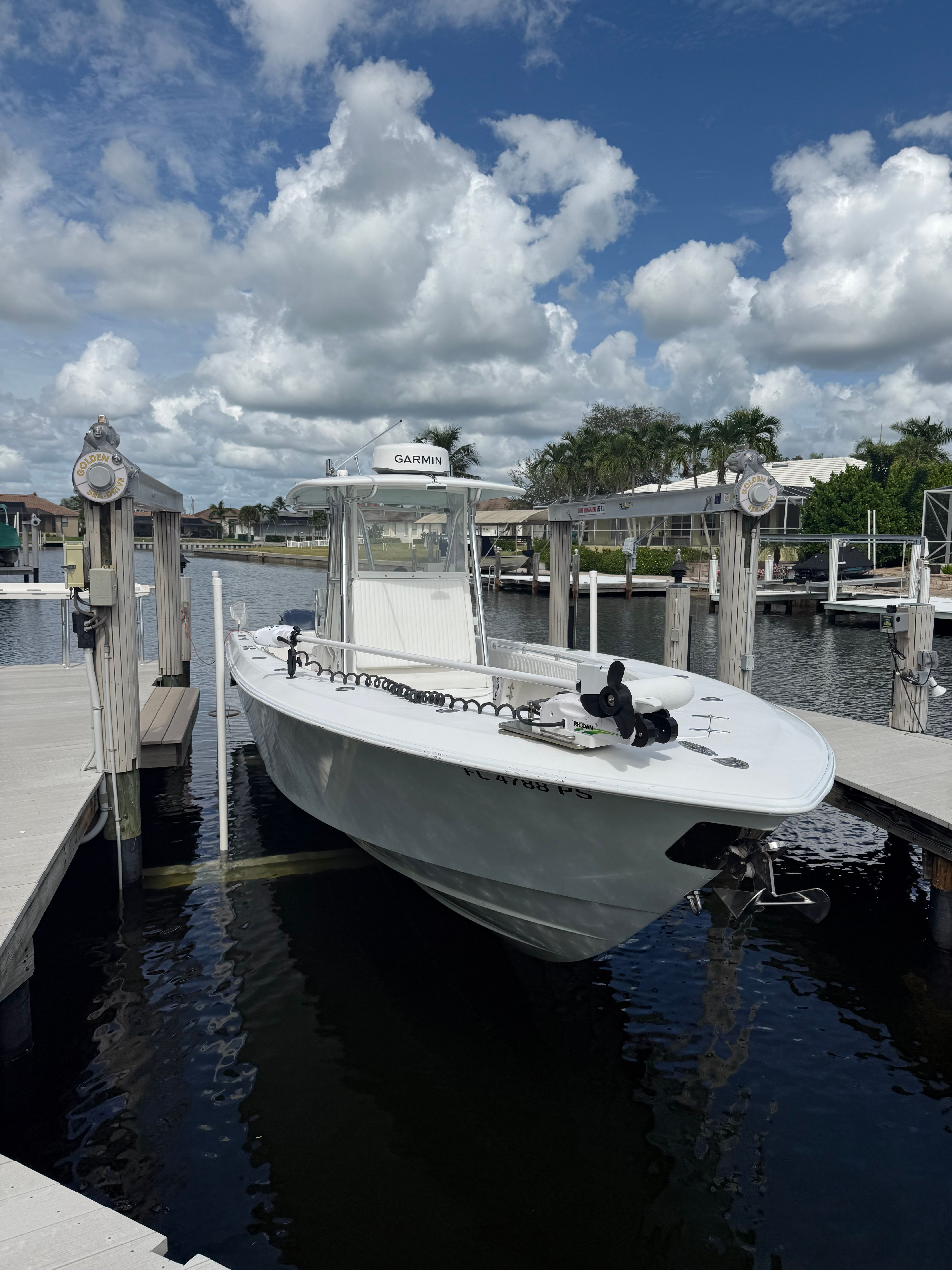 2012 Contender 32 ST boat docked in sunny marina.