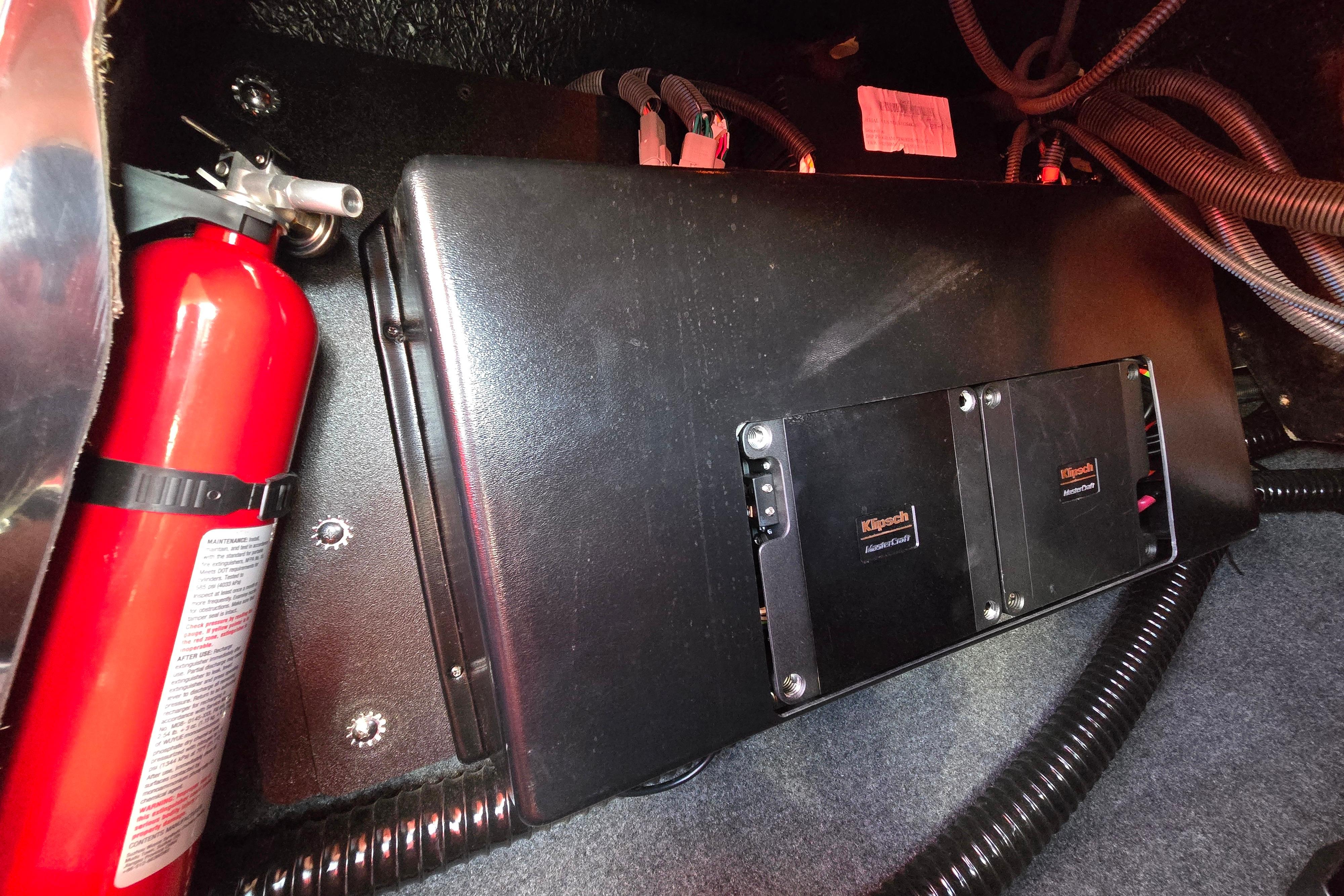 2019 MasterCraft XT25 interior with fire extinguisher and Klipsch audio components.