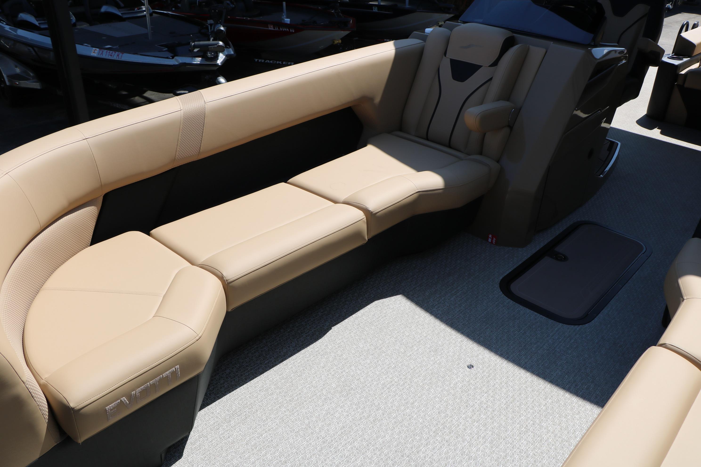 Luxurious seating on the 2026 Evotti 725 CS Tri-Toon boat, featuring beige upholstery.