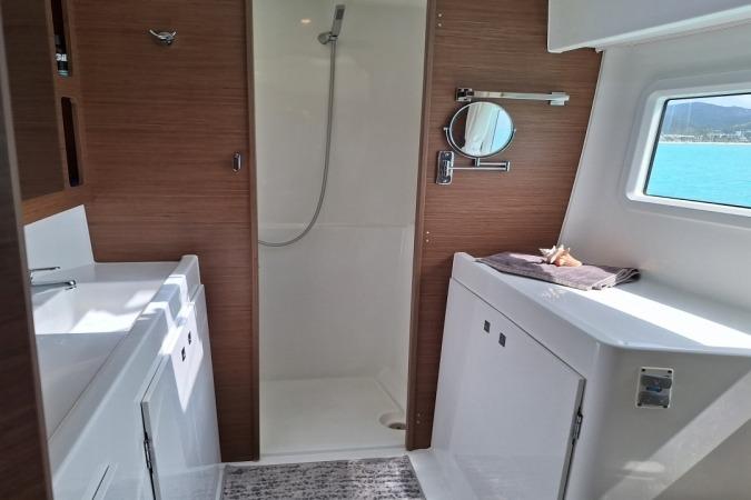 Modern bathroom interior of 2018 Lagoon 42 yacht with shower and vanity.