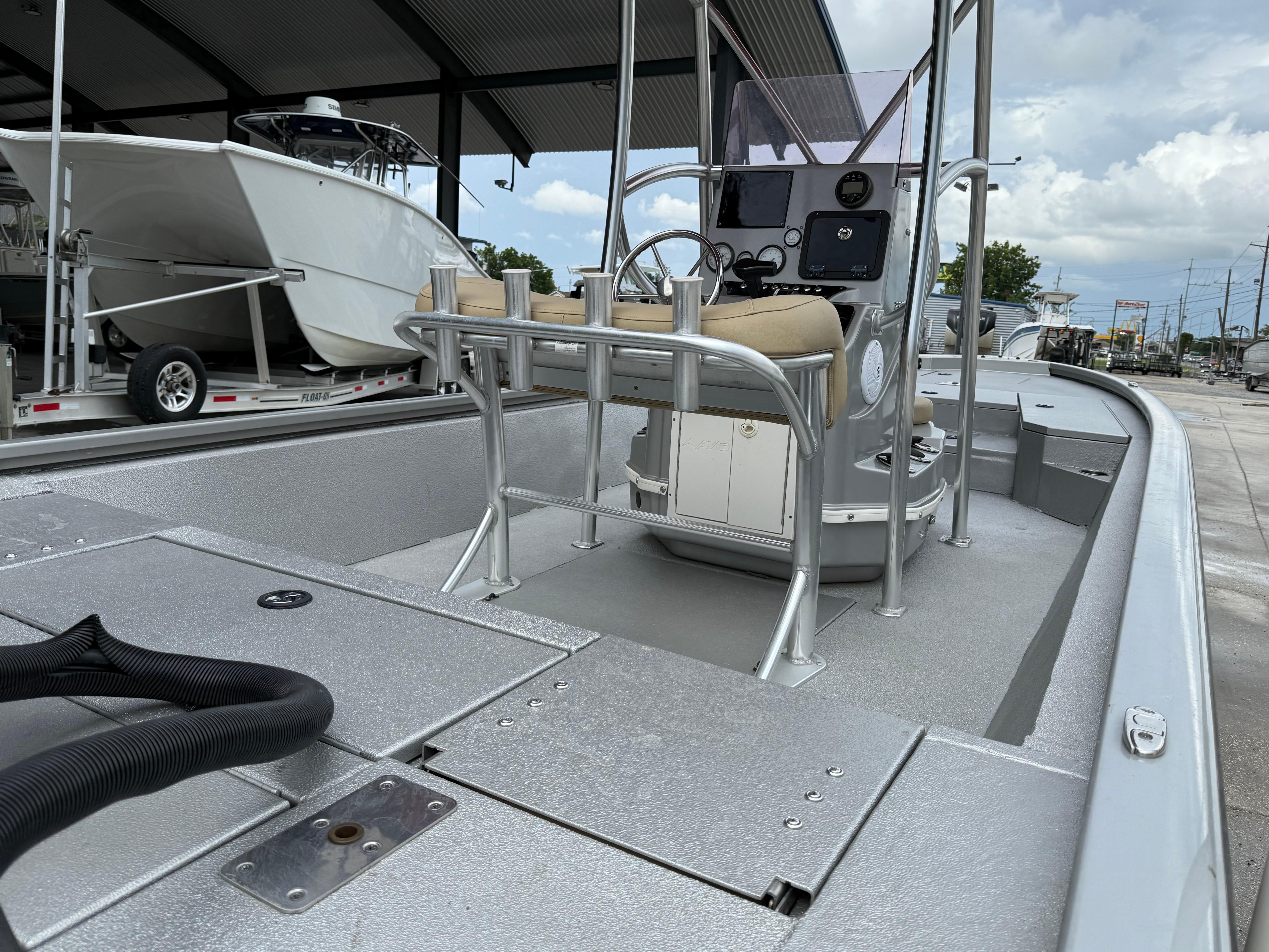 2020 Avid 23 FS Platinum boat interior with console and seating, docked under a canopy.