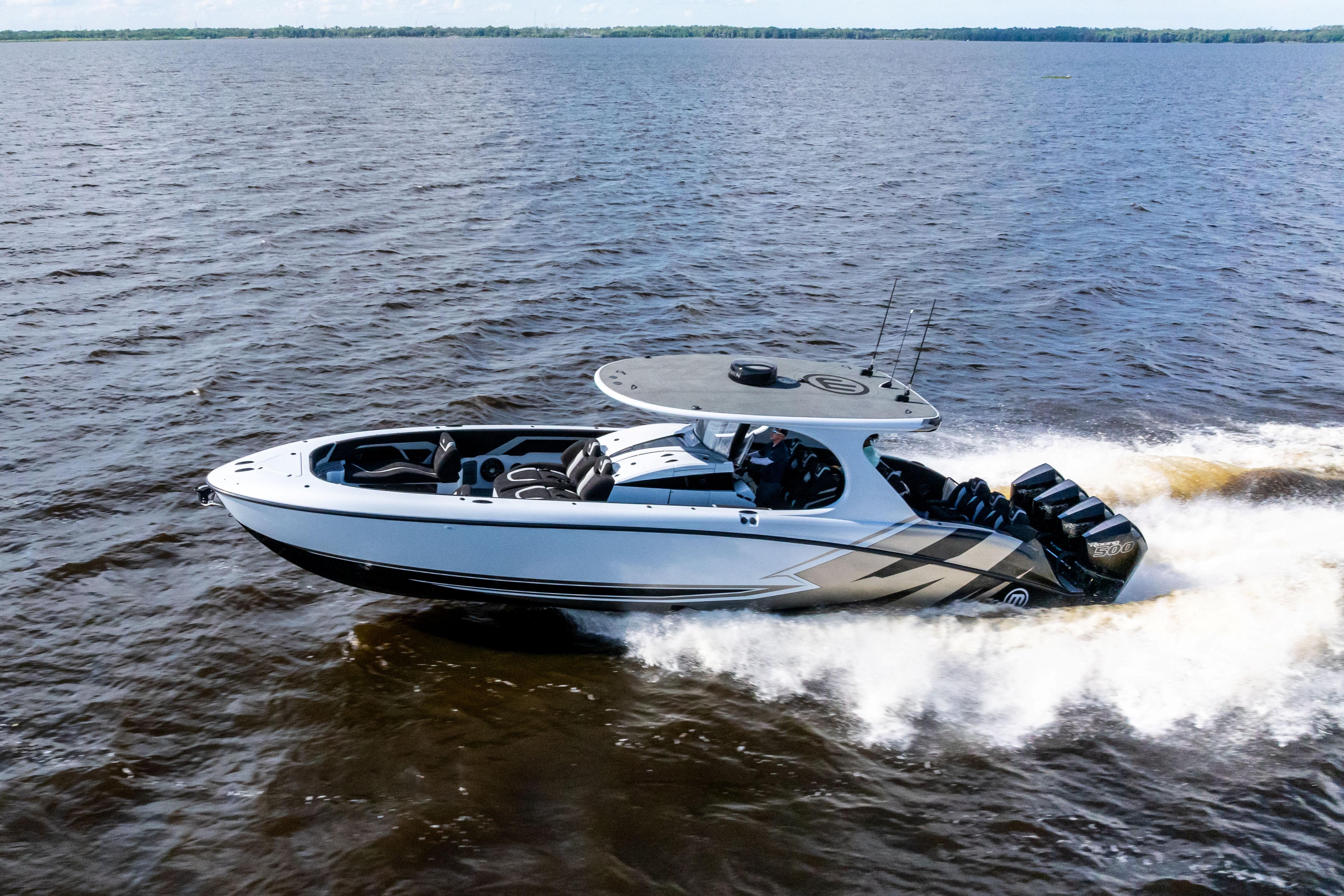 2027 Mystic Powerboats M4200 speeding on open water, showcasing sleek design and powerful engines.