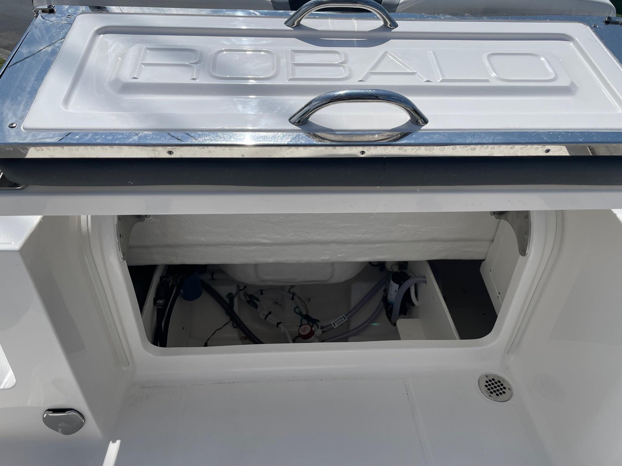 2025 Robalo R230 Center Console storage compartment with open hatch.