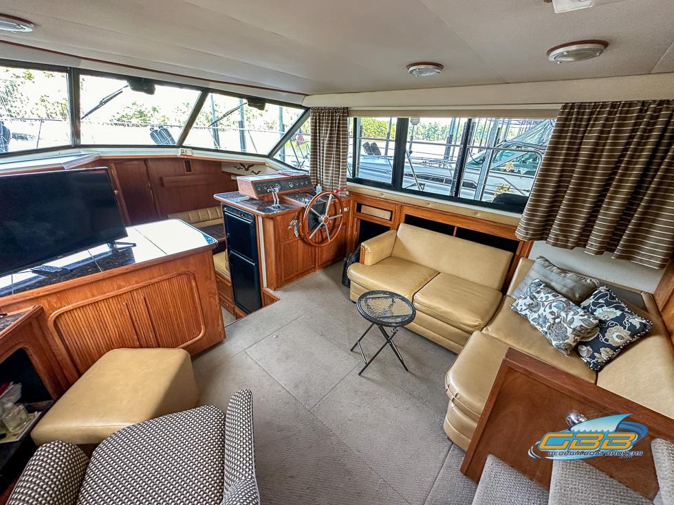 1989 Carver 3807 Aft Cabin interior with cozy seating and helm station.