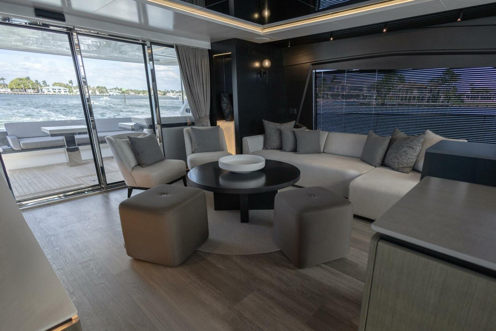 Luxurious interior of 2023 Pearl 72 yacht with modern seating and ocean view.