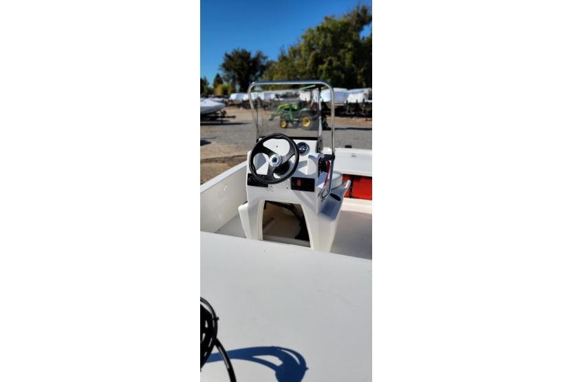 2026 Mako Pro Skiff 13 CC boat console with steering wheel and controls.