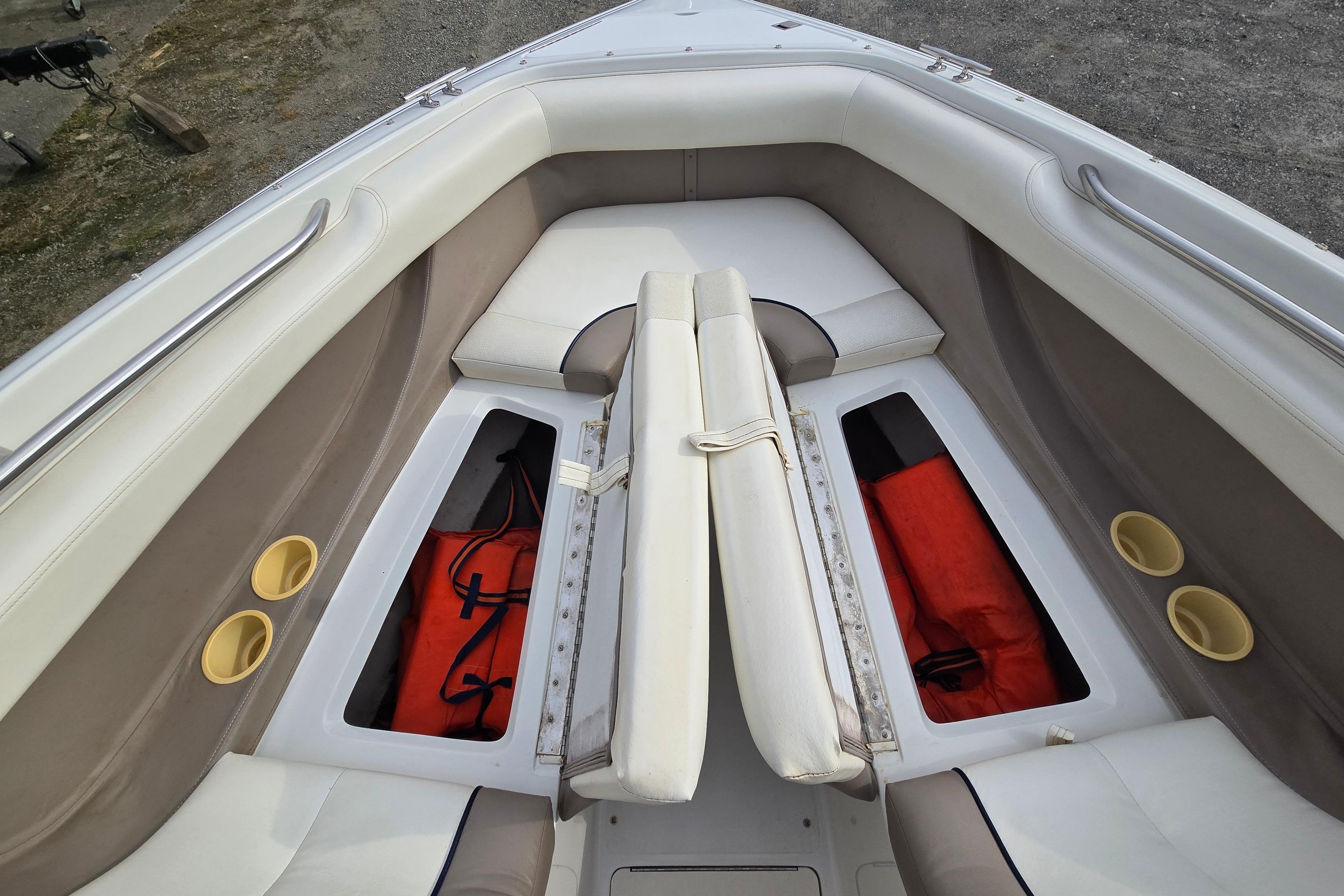 Interior of a 2000 Cobalt 246 boat with storage compartments and seating.