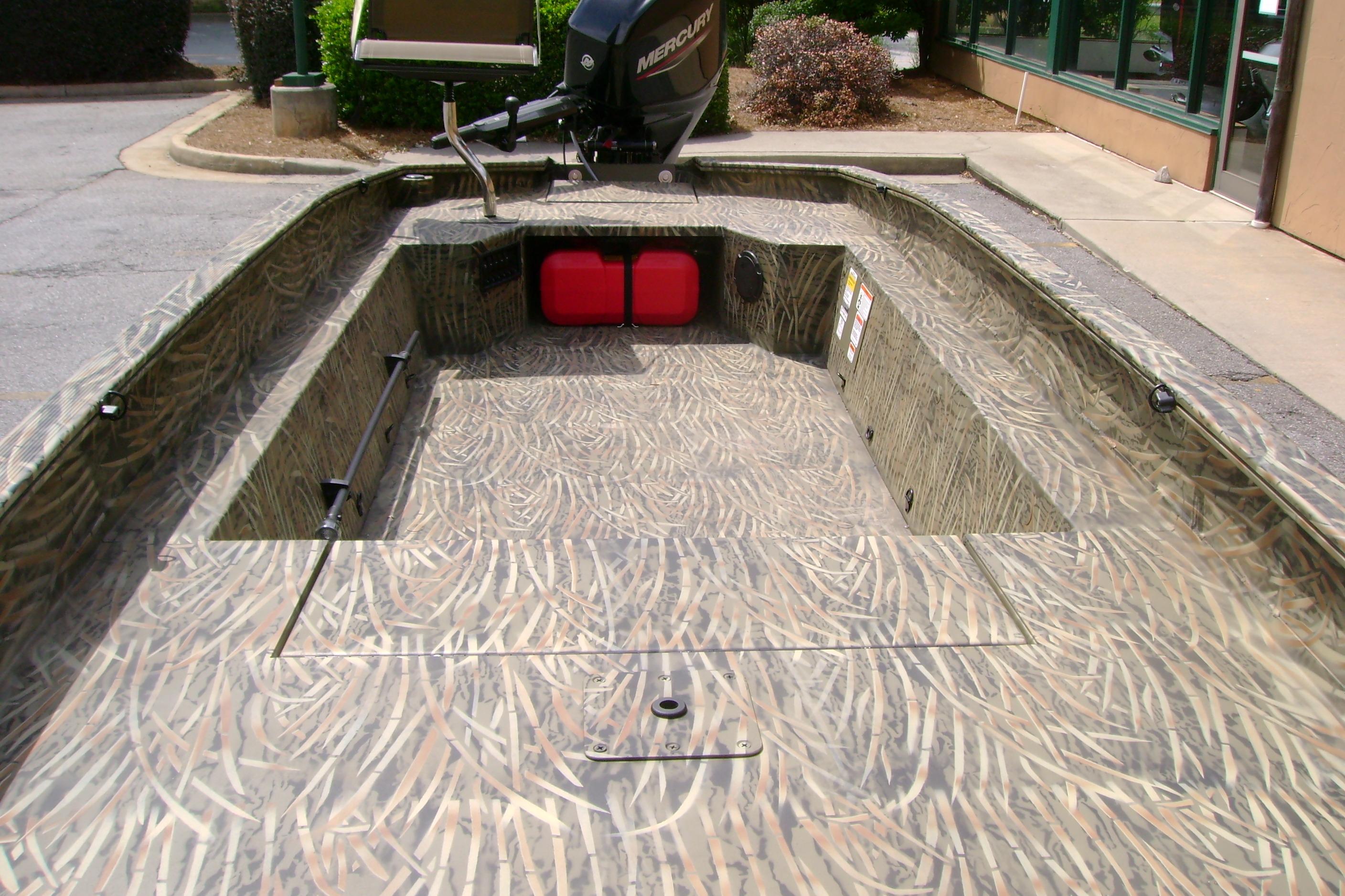 2026 Tracker Grizzly 1650 T Prairie Wings Edition boat with camo interior and Mercury motor.