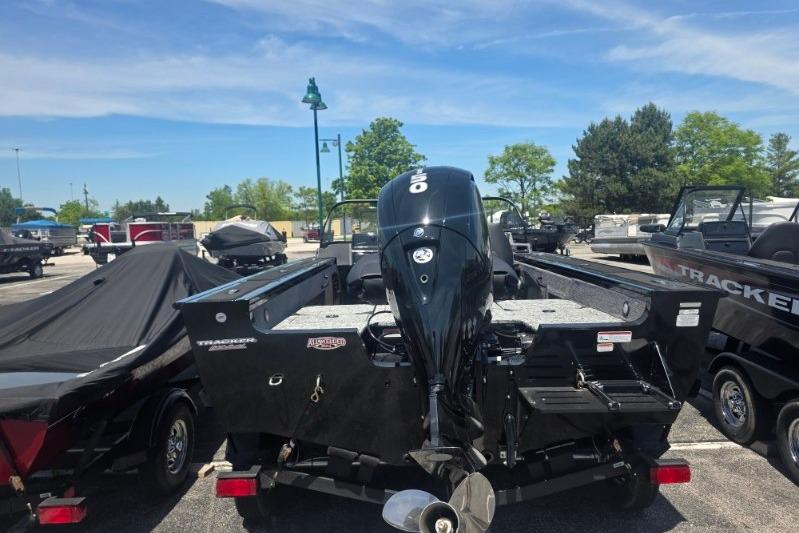 2026 Tracker Targa V-18 Combo boat with outboard motor in a parking lot.