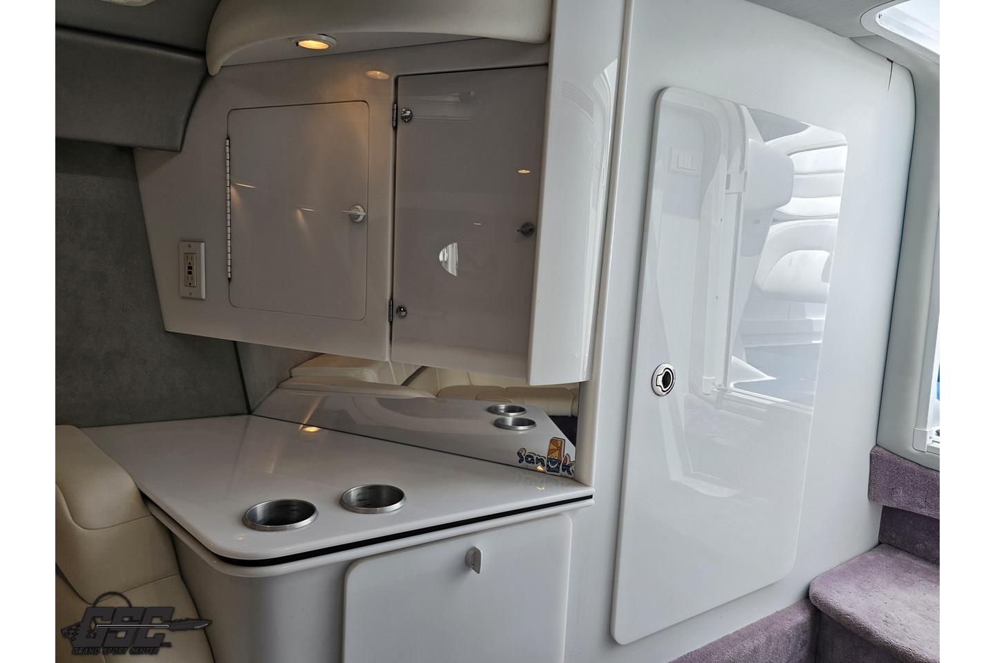 Interior of 2002 Formula 382 FASTech boat, featuring sleek cabinetry and cup holders.