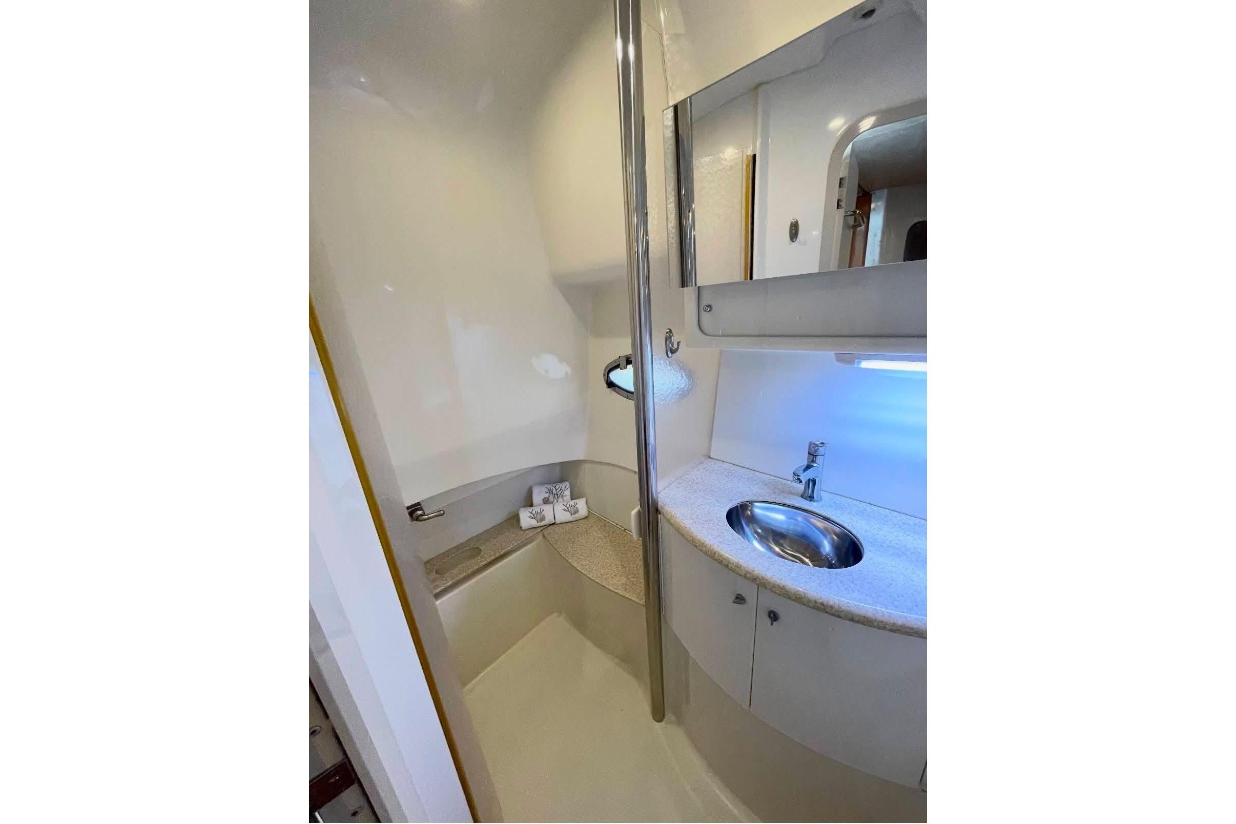 Bathroom interior of 2003 Formula 40 Performance Cruiser with sink and mirror.