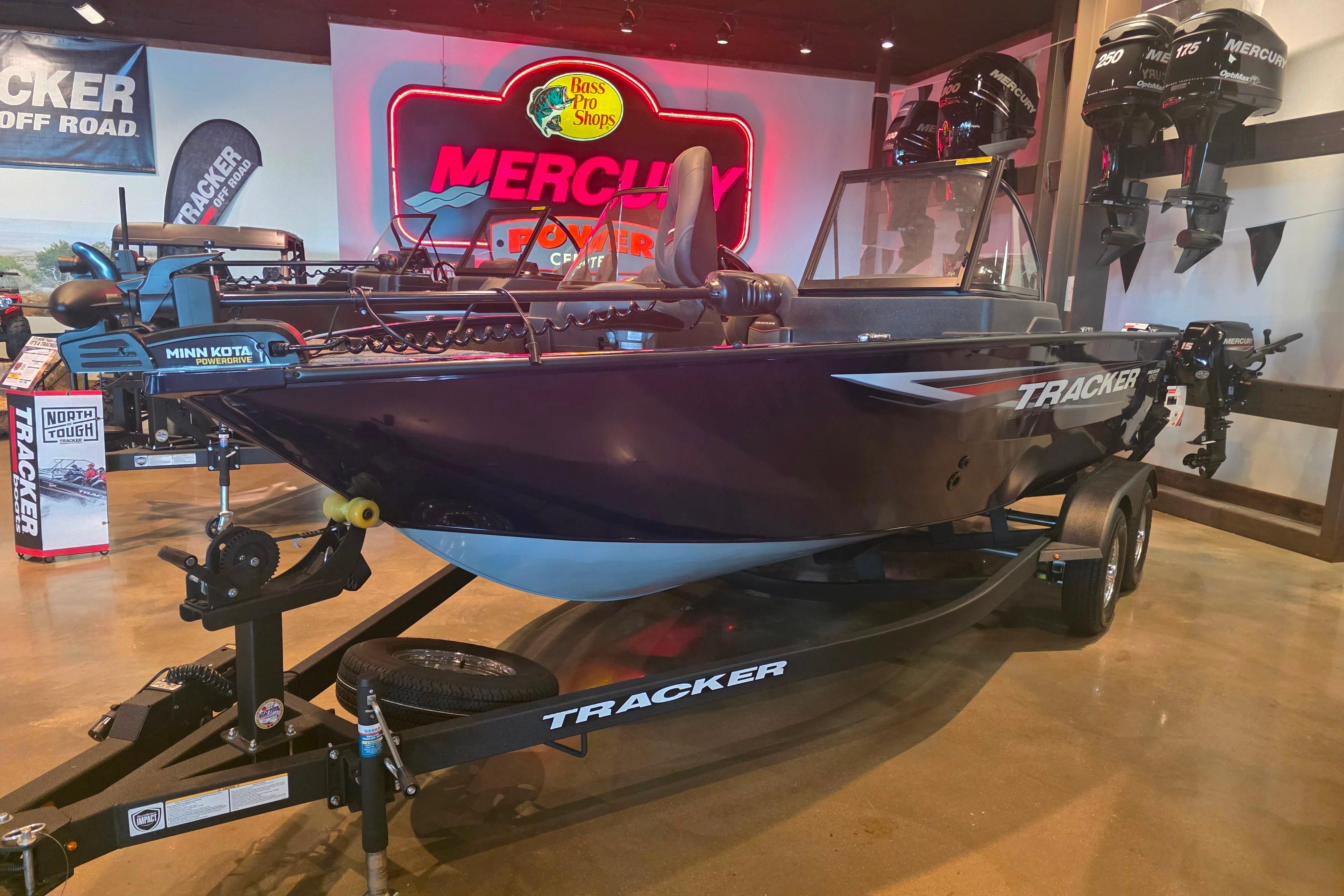 2026 Tracker Pro Guide V-175 Combo boat displayed at Bass Pro Shops showroom.
