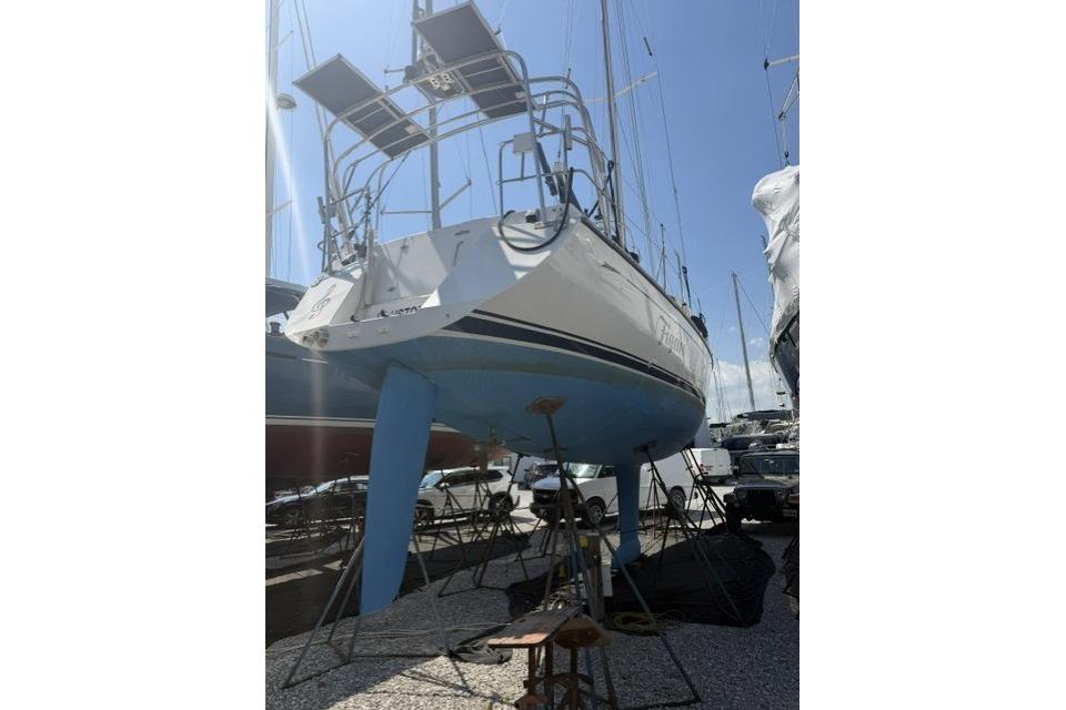 Sailboat Saga 43, 2002 model, on dry dock with solar panels, blue hull.