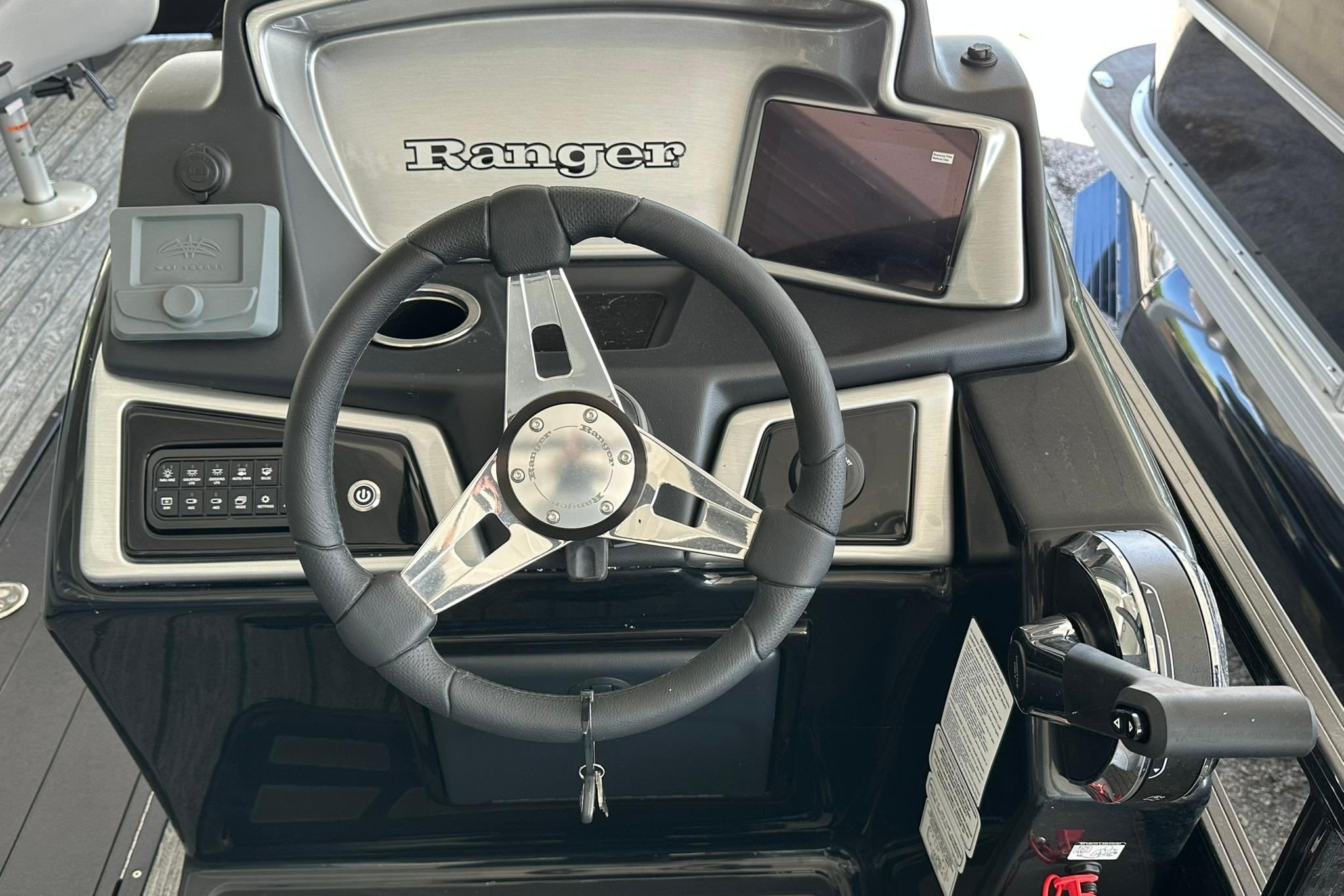 2026 Ranger Reata 223FC boat dashboard with steering wheel and controls.