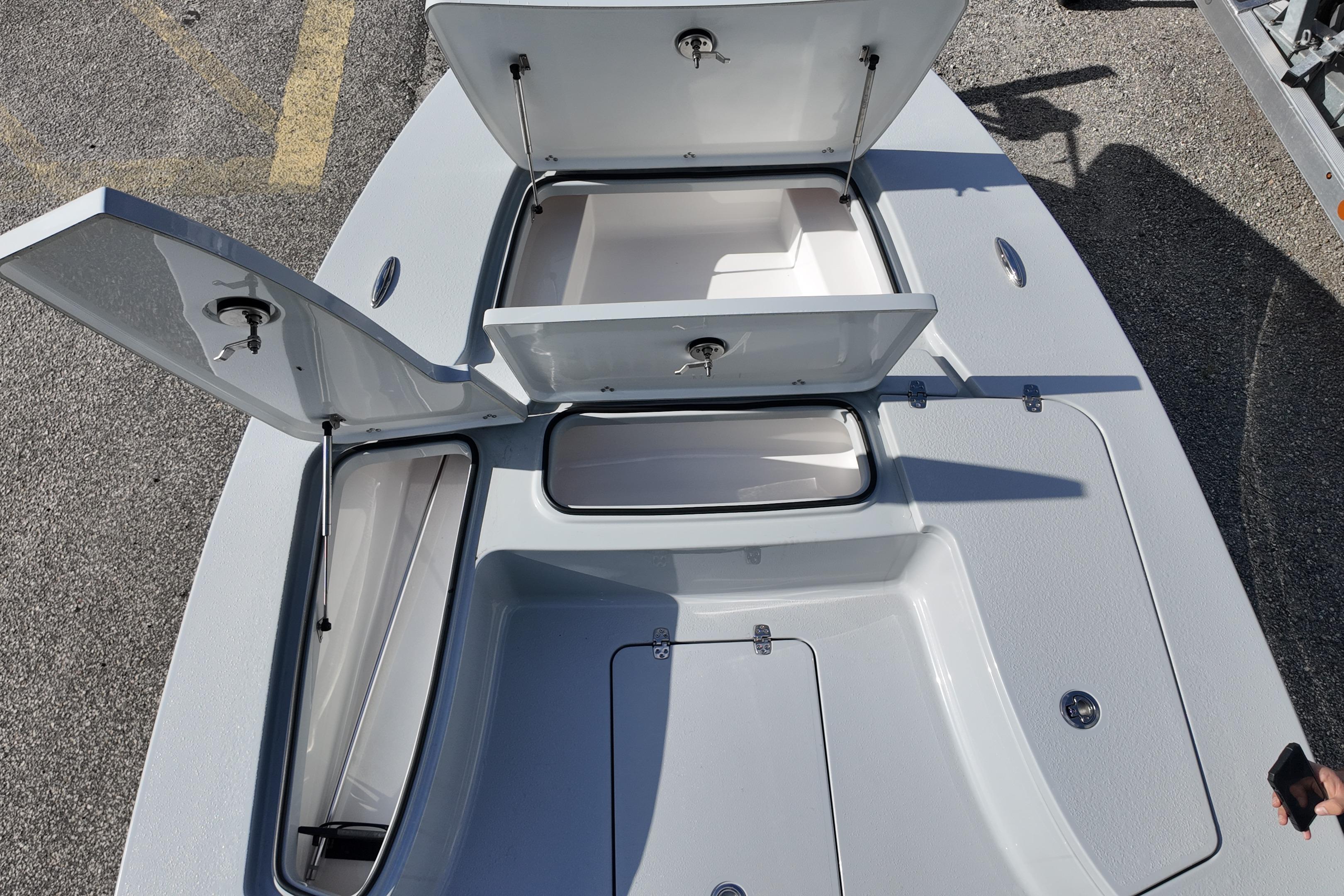 2026 Blazer Bay 675 Ultimate Bay boat with open storage compartments on deck.