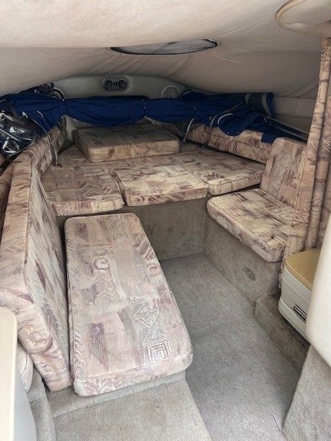 Interior of a 1999 Crownline 266 CCR boat with cushioned seating.