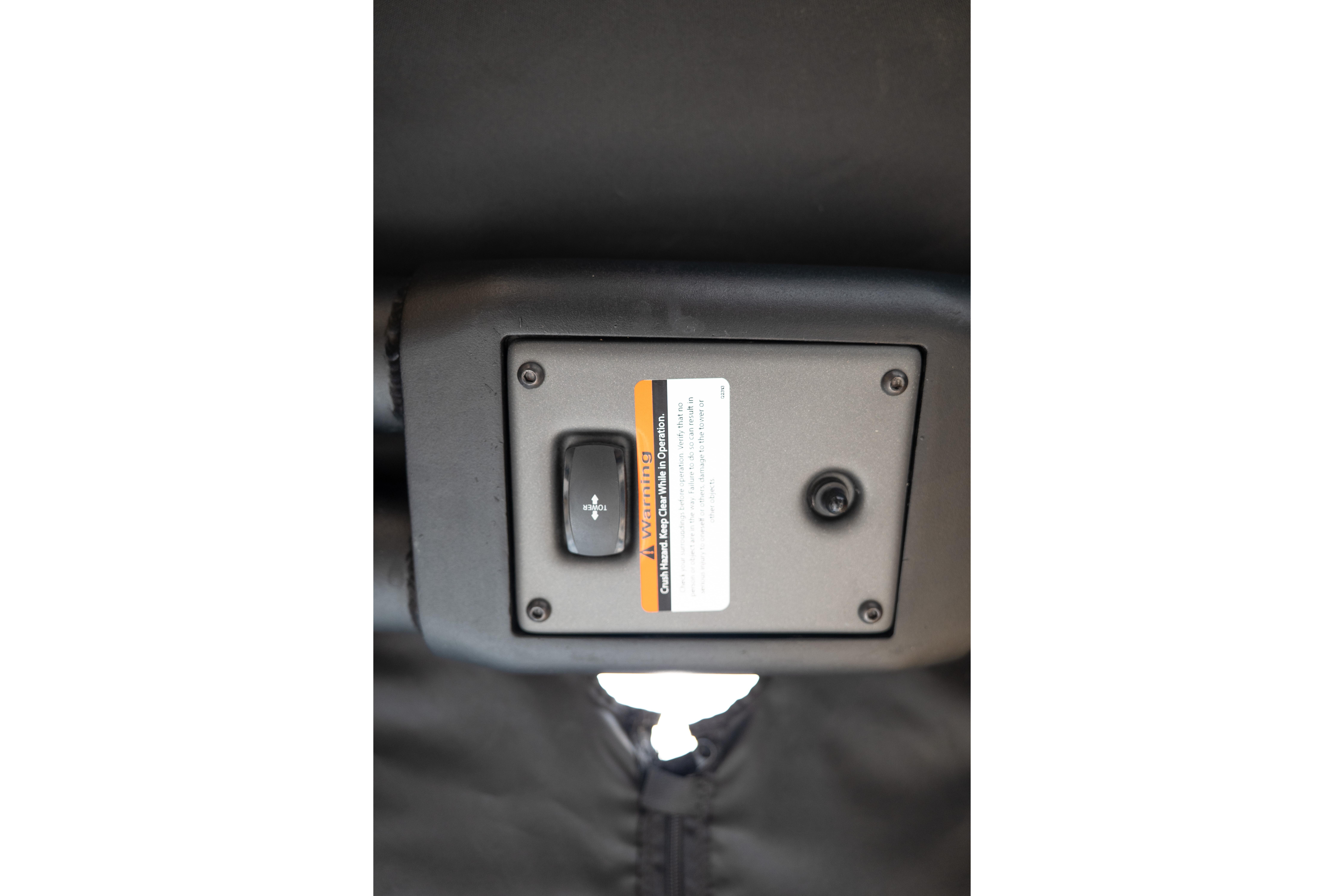 2024 Tigé Z5 boat control panel with warning label and switch.