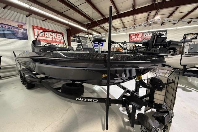 2024 Nitro ZV21 boat displayed in showroom with Tracker Boats signage.