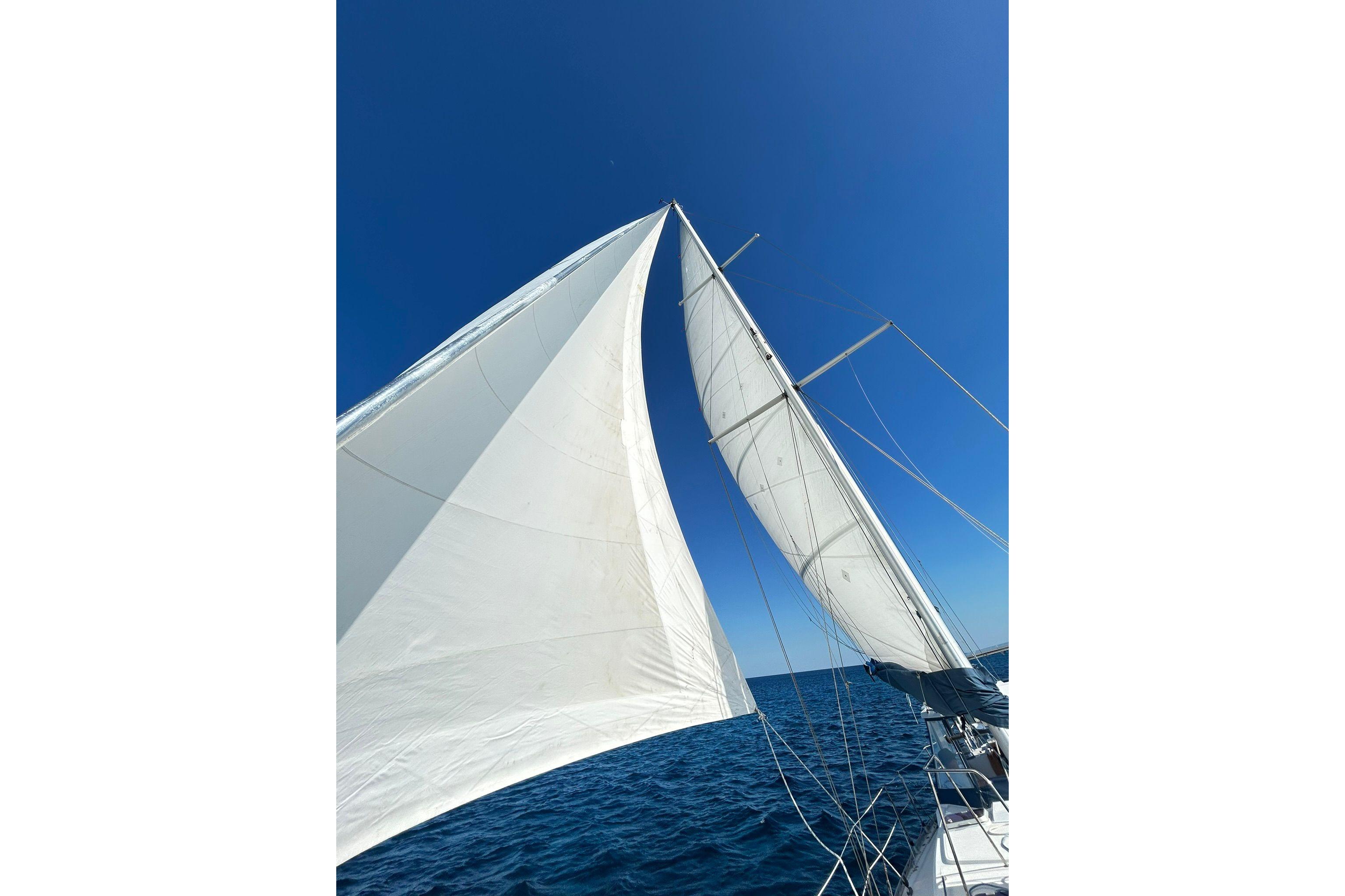 Sailing on a 1987 Gulfstar CSY 50 Pilot House under clear blue skies.