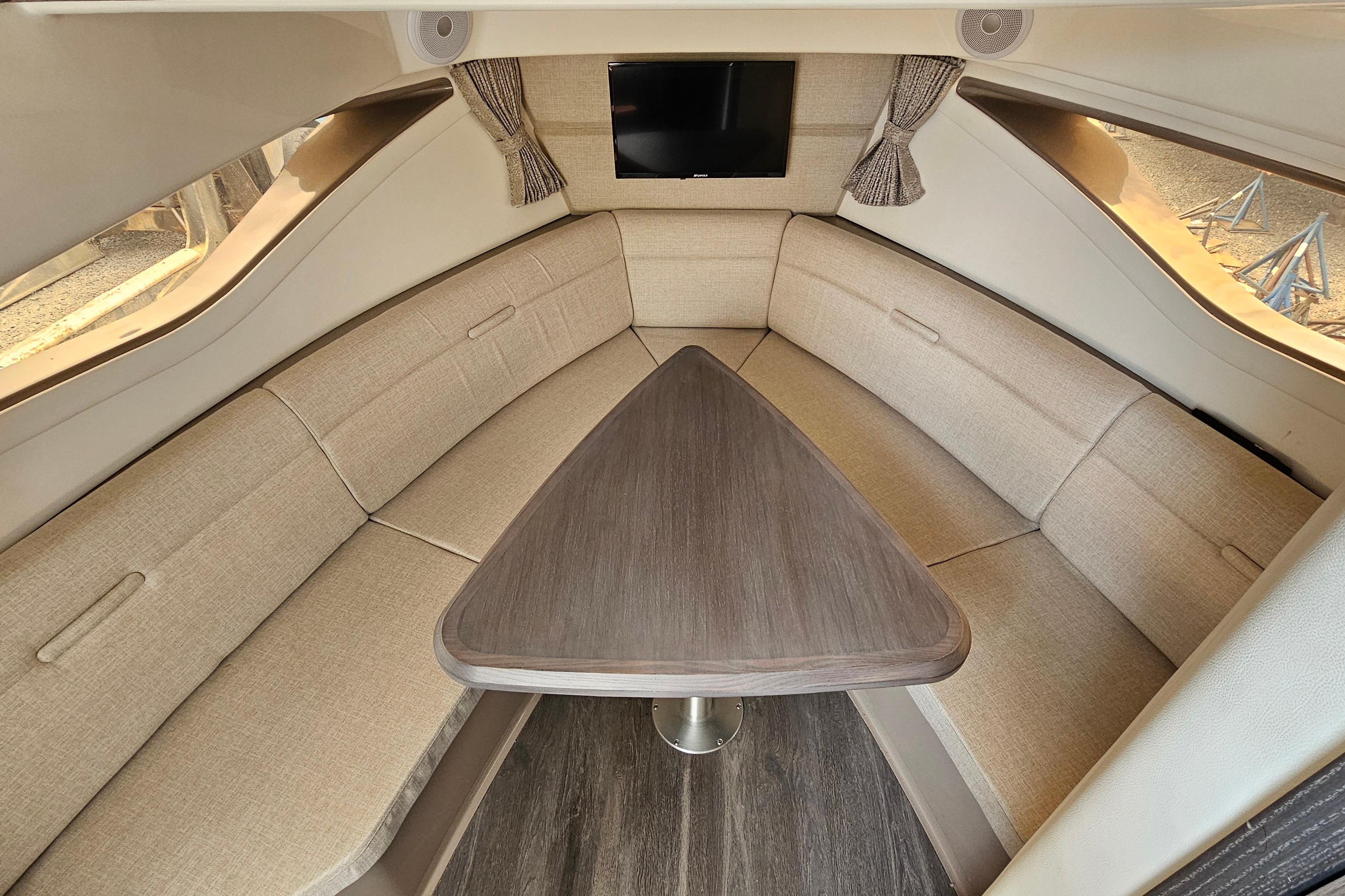 Interior of 2023 Sea Ray Sundancer 320 yacht with elegant seating and table.