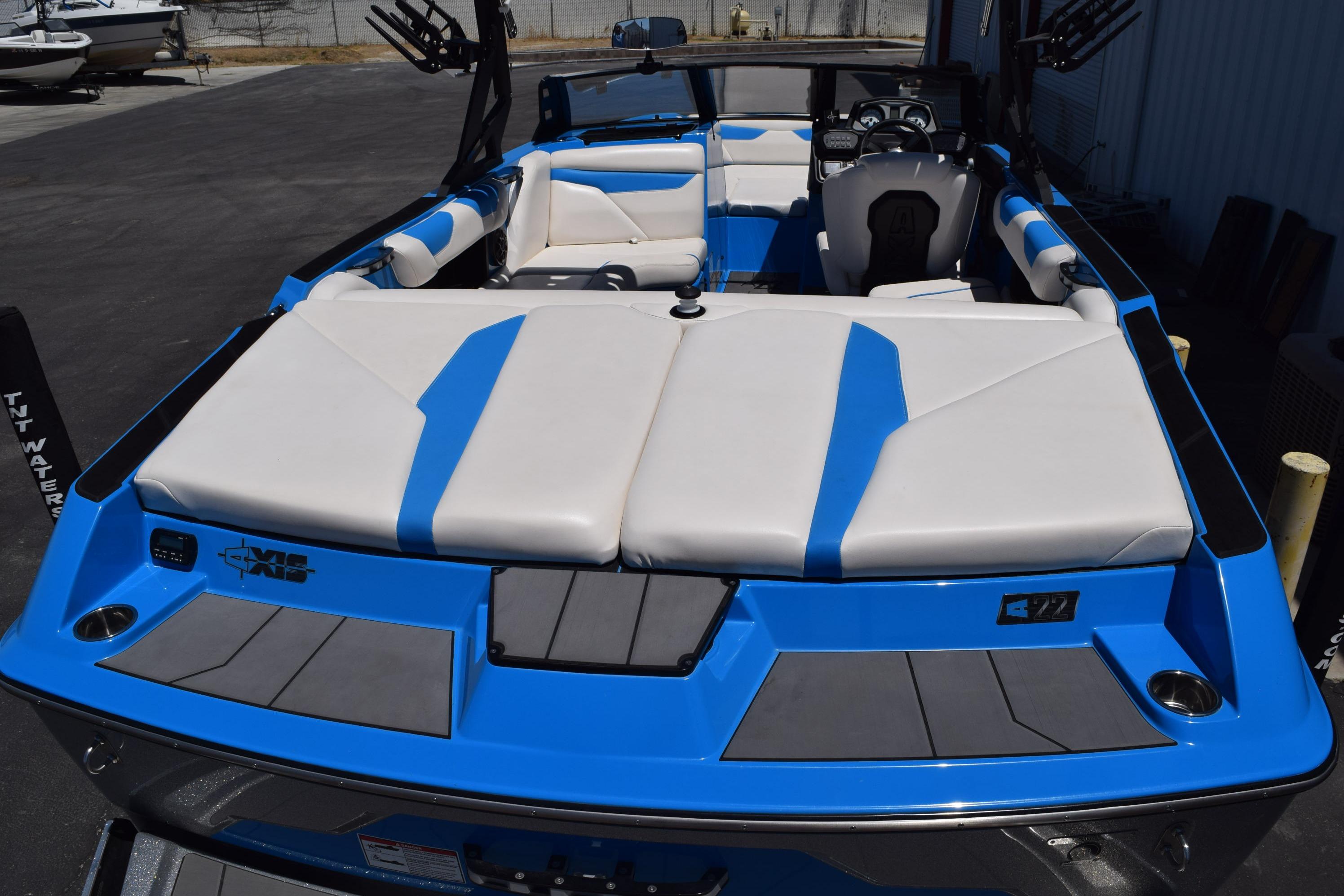 2019 Axis A22 boat with blue and white interior, docked outdoors.