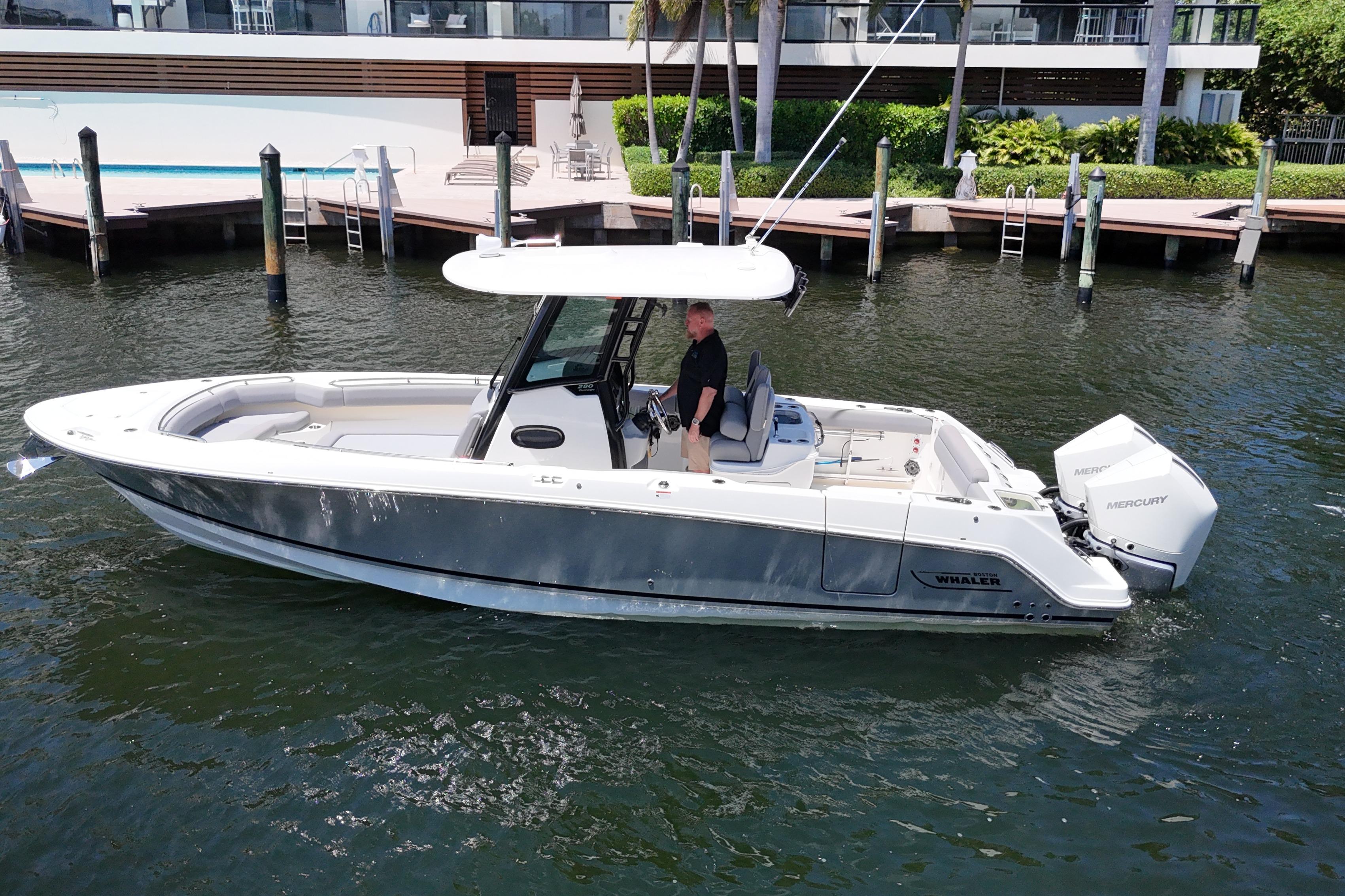 2024 Boston Whaler 280 Outrage boat on water, dockside view.