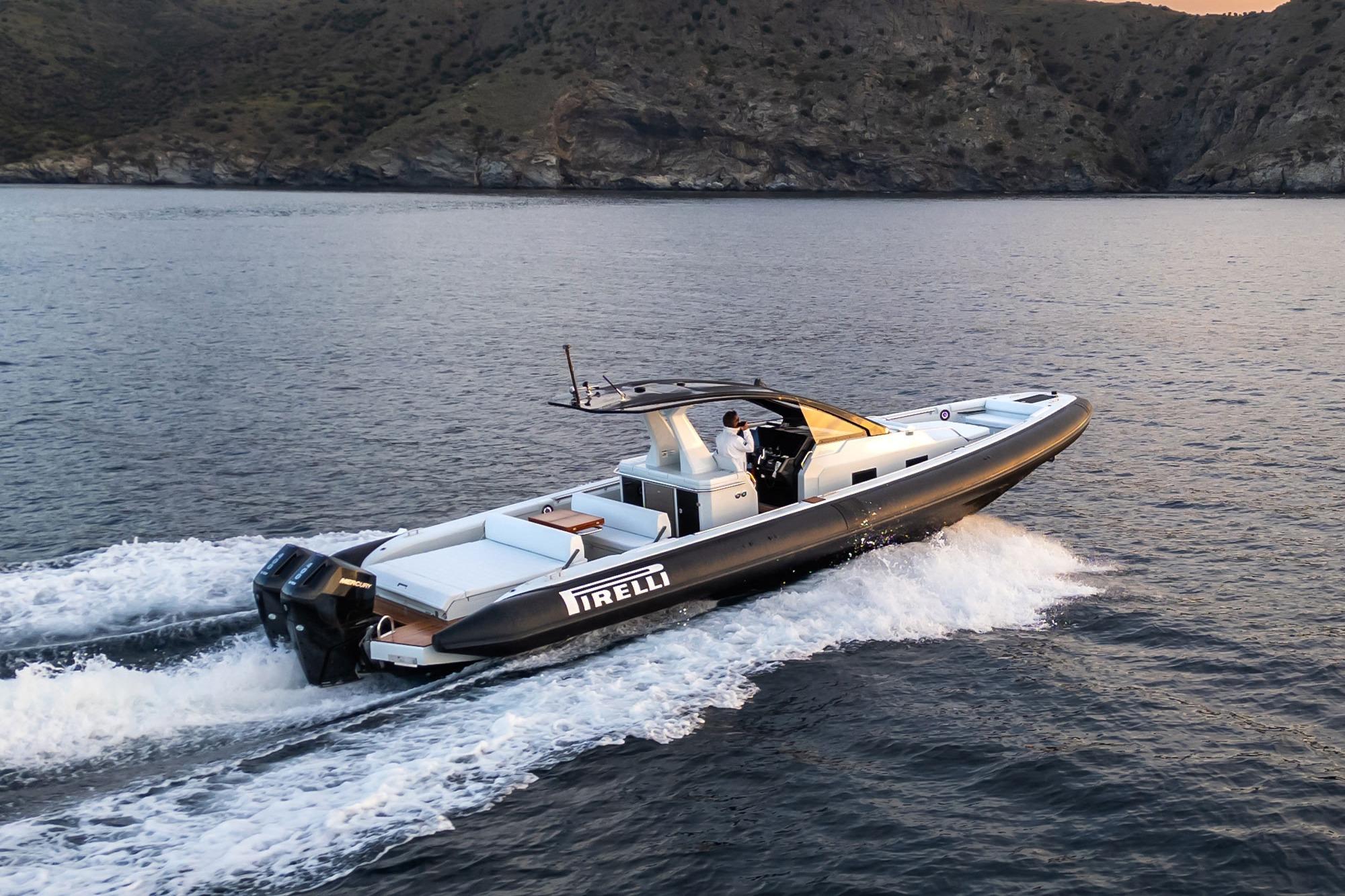 2026 PIRELLI TECNORIB 42 boat cruising on open water near rocky coastline.
