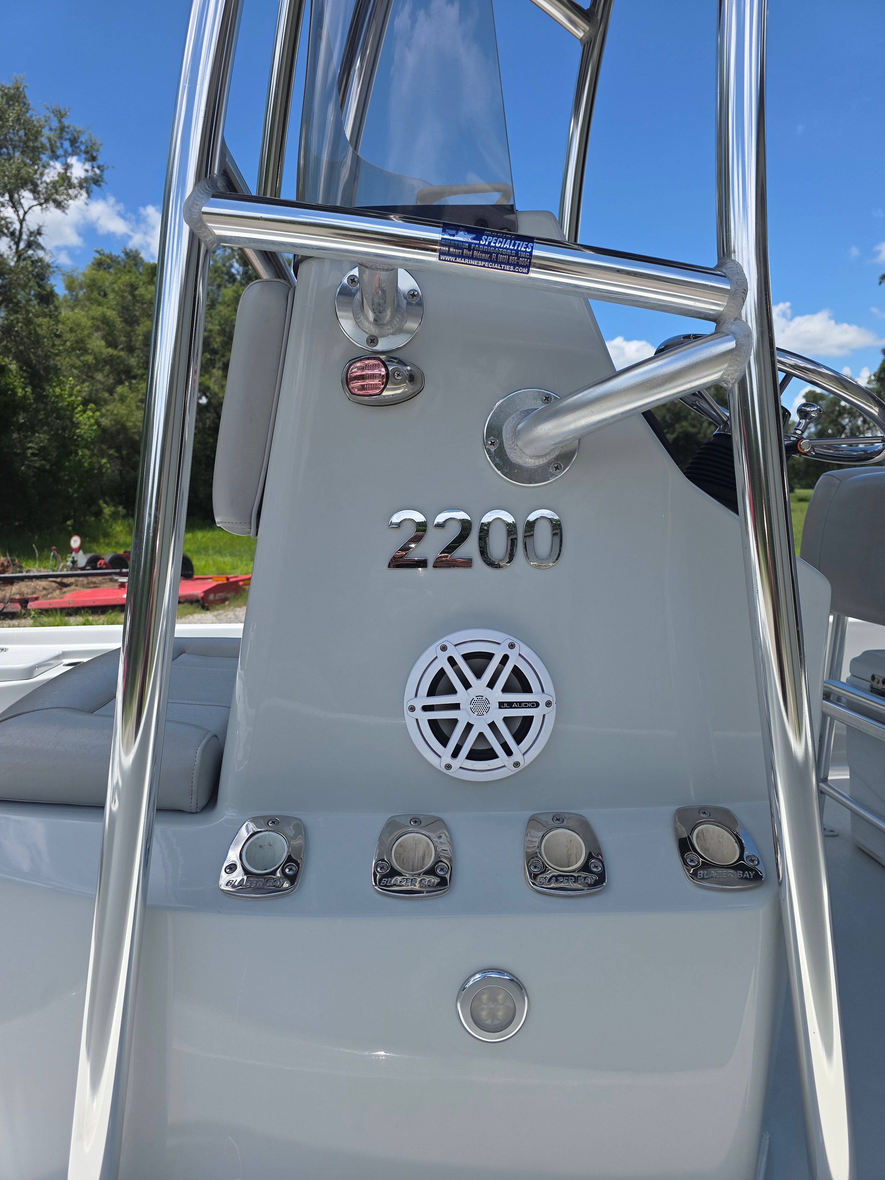 Close-up of a Blazer Bay 2200 boat's helm with stainless steel details.